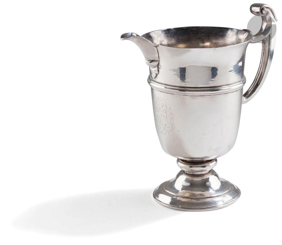 SPAIN OR ITALY LATE 17th CENTURY EARLY 18th CENTURY
Formerly plated metal ewer called helmet. It rests on a pedestal whose fixation has been modified. The body is engraved with a large coat of arms surmounted by a knight's helmet in a frame of leafy scrolls, underlined by a rush of strong fillets. The spout with overflow is welded on piece as the handle with stick.
Height : 23,4 cm 
Condition : re-silvered and restoration at the base