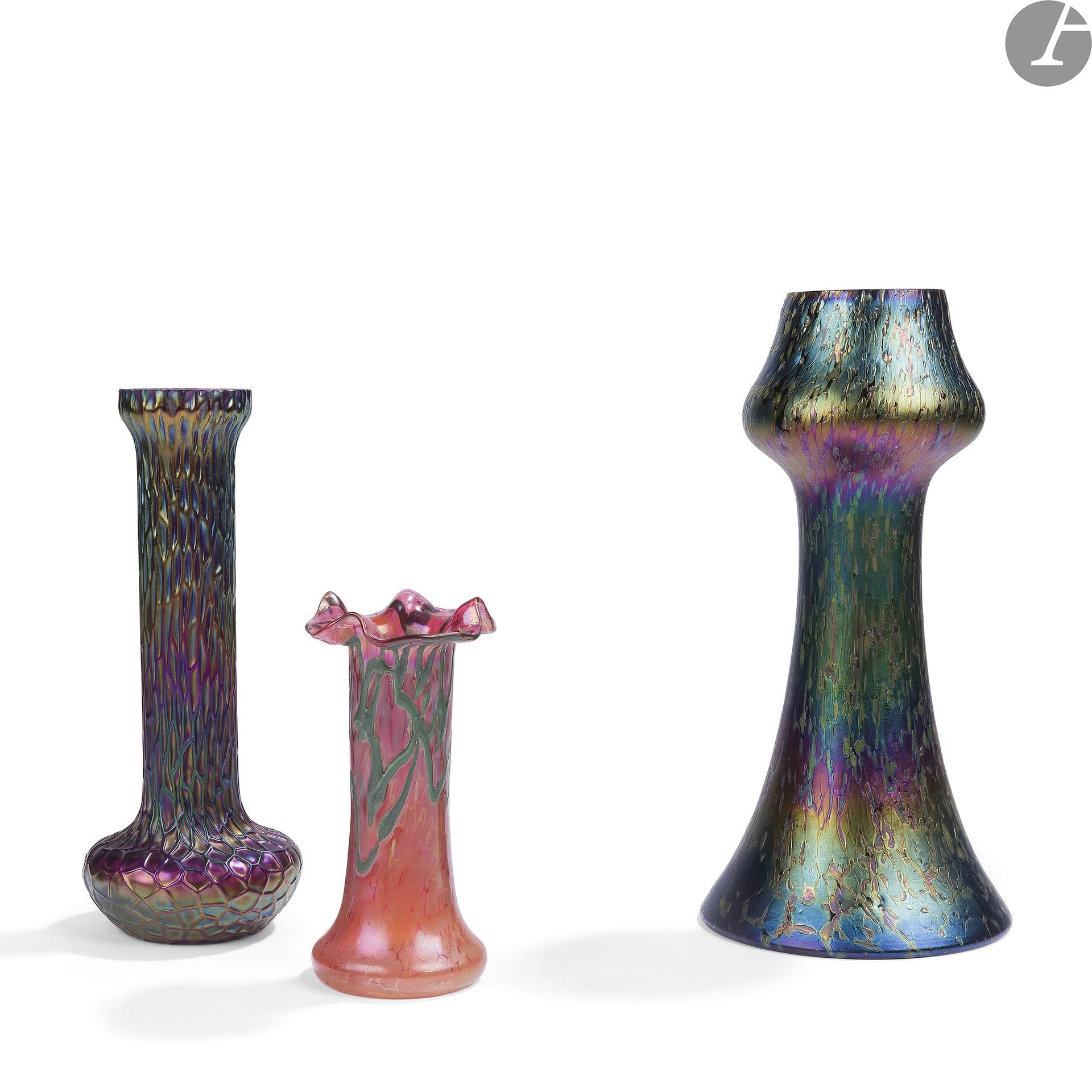 AUSTRIAN GLASS - (LOETZ - KRALIK - PALLME-KÖNIG & HABEL GLASFABRIK) - 3 WORKS 
Butterfly, the design of the decoration about [1898]
. Glass proof with rich colorations and iridescence forming the title decoration. H. 24,5 cm 
HammeredVase
soliflore with bulbous base. Glass proof with rich colorations and iridescences forming the title decoration. Some chips around the neck. H. 21 cmImpressionVase

with a corolla neck. Glass proof with rich colorations and iridescences forming the title decoration. H. 14 cm





