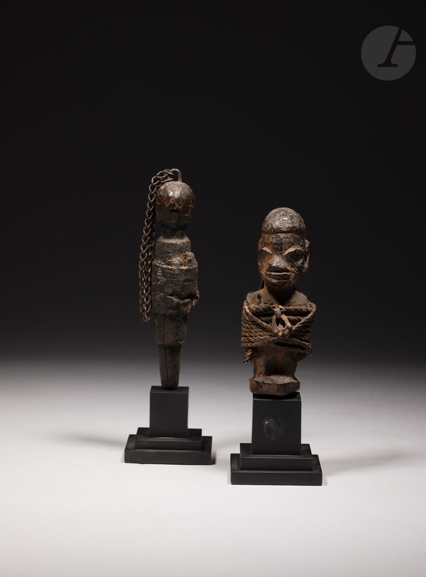 A lot of two small old voodoo stake sculptures, one of which is in a Nago or Yoruba style with a large attachment and the other in a more schematic style with an attachment around the body and a metal chain nailed to the top of the skull. They are devoid of their peg.

Fon, Benin

Wood, cords, cowrie shell, metal chain, and other elements, beautiful and old patina of use.

H. 12 and 14 cm 



Provenance:

Anne and Jacques Kerchache Collection