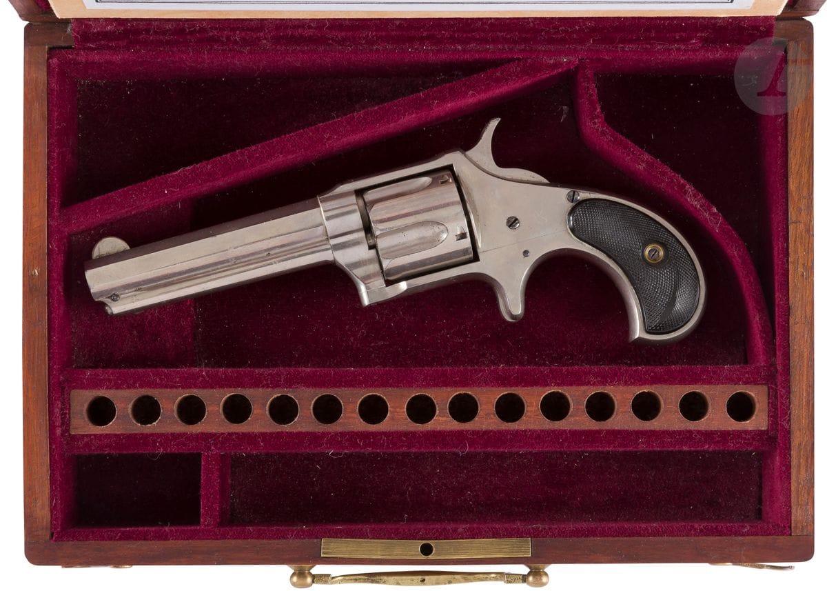 Remington Smoot New Model No. 3" Revolver, five-shot, .38 caliber short centerfire.
Ribbed barrel, fluted with "Remington & Sons. ILLION. N.Y PAT. W. S. SMOOT OCT 21 1873".
Hollow barrel. Closed carcass. Spurred trigger. Checkered ebonite stock plates.
Length : 20,7 cm
B.E. (polished finish). 

In a modern mahogany case, lined inside with burgundy velvet, with a dimpled slot for cartridges and its key.
Case : 18 x 25,8 x Height : 6,5 cm
B.E.