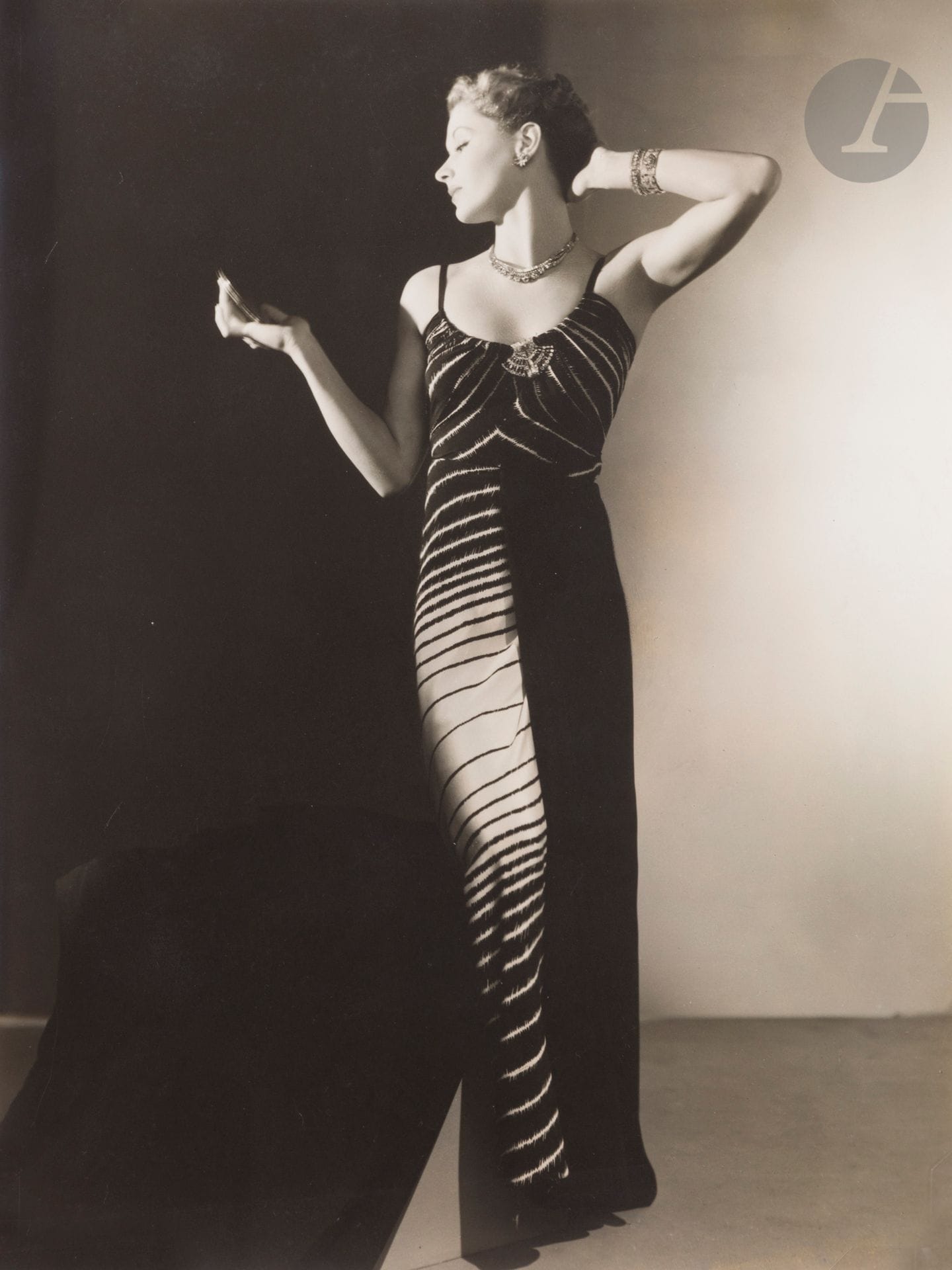 George Hoyningen-Huene (1900-1968
)Lisa Fonssagrives in a Madame Grès dress for Harper's Bazaar, summer 1938
. Stamp "Photographer Hoyningen-Huene" and handwritten annotations on the back.
28,5x21cmBibliography

: 
Martin Harison - David Seidner, Lisa Fonssagrives, thirty years of classic fashion photography, Munich, Schirmer/ Mosel, 1990, p. 118


.

 
 

Provenance of n° 124 to 134: 
Succession Madame Grès, Hôtel Drouot, Paris.
The career of Germaine Émilie Krebs, known as Alix, then Alix Grès and finally Madame Grès, spans the 1930s to the 1980s, and traverses the changes in the fashion industry while maintaining a singular style based on draping and a sculptural vision of clothing: "I wanted to be a sculptor. For me, it's the same thing to work with fabric or stone". A privileged witness to the birth and expansion of communication through photography, Madame Grès collaborated from her first collections with many artists such as Man Ray, Cecil Beaton, Horst P. Horst, Genia Rubin and George Hoyningen-Huene.









