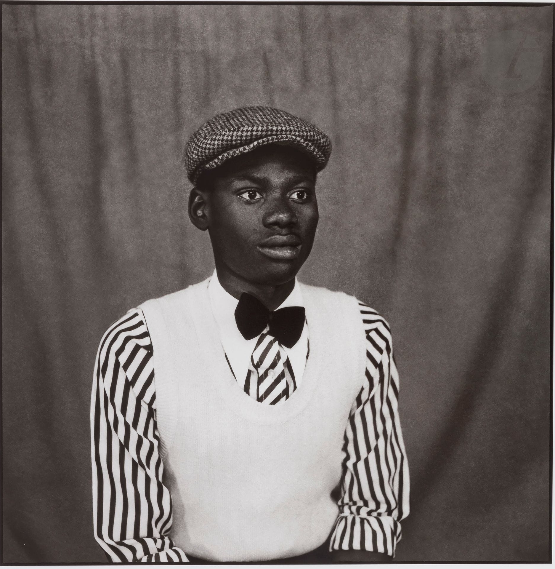 
Sanlé Sory (1943) 

The elegant one with the bow tie. Bobo-Dioulasso. Burkina Faso, 1974.

Pigment print (2019), signed and dated in pencil on verso. Artist's proof (AP) from an edition of 8 copies.  A certificate of authenticity accompanies the work. 

Image: 36x36cm 

Sheet: 50x40cm 



 Ibrahima Sory Sanlé began his photographic career in Bobo-Dioulasso the year his country gained its independence in 1960. As a young apprentice to a Ghanaian photographer, he worked with a camera, before developing and printing, and then moving on to the 6x6 format like most African photographers of his generation. A privileged witness to the rapid evolution of his country and his city, long the economic and cultural capital of Upper Volta, Sanlé expresses in images the head-on collision that occurred between modern life and the traditions of the Hauts Bassins region. He began his career photographing road accidents. In the mid-1960s, he set up the Volta Photo studio, which was to become the great studio of Bobo-Dioulasso. As a photographer who is committed to his work, he follows his motto to the letter, "when you love something, you give yourself totally to your passion". A prolific photographer, he distinguishes himself from the competition of the three other large local studios, thanks to his painted backgrounds, designed by himself, whether it is a modern city, a seashore, an ancient column or an airplane bridge. Whether still or in motion, his subjects evoke the distant and melancholy daily life of the landlocked cities of the African continent, but also the vitality of the Voltaic youth. His astute eye documents with an unfeigned candor to the fusion operating then between tradition and modernity.



Bibliography :

 - Matthew S. Witkovsky, Sanlé Sory. Volta Photo, Gottingen, Steidl / The Art Institute of Chicago, 2018. 

- Sory Sanle, Volta Photo Studio, New York / Bordeaux, Yossi Milo Gallery / Tezeta, 2018. 

- Sory Sanlé, Volta photo 1965-1985, London, Reel Art Press, 2017.



African Studios, a private collection - N° 293 to 329.

