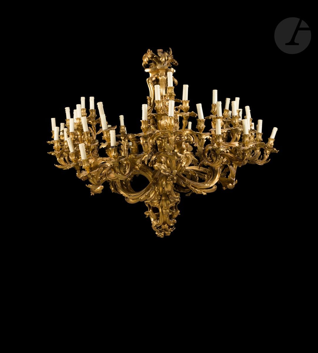 Monumental gilt bronze chandelier with fifty-four lights, decorated with foliage and flowers, the four main arms divided into three branches and joined to the shaft by rocaille clasps on which are seated winged children, one holding a tower symbolizing the Marquise de Pompadour, the openwork shaft with balusters and palm tree decorated with birds and children-Cupidon; (small accidents and missing; drilled for electricity).
After the model made for the Marquise de Pompadour.
 Signed by Charles Crozatier (1795-1855).
Louis XV style, mid 19th century.
H. 130 cm, L. 145 cm (approx.) 

 This chandelier is freely inspired by the two nine-light chandeliers made for the Marquise de Pompadour by the bronzier Jacque Caffieri, now kept in the Mazarine library in Paris. In 1833, Crozatier cast the statue of Napoleon I which adorned the Vendome column until it was replaced during the Second Empire.