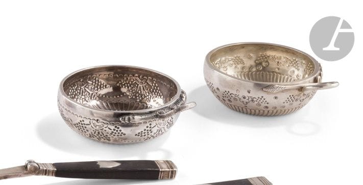 FRANCE PARIS PROVINCE XIXth CENTURY
Two silver wine cups with snake handle:
- AURILLAC 1819 - 1838, second title, embossed with twisted gadroons, then ocelots framing stylized bunches of grapes, engraved A. PONS. DAUFI.
 Goldsmith : Jean BEILLIE ANDRAL, registered in 1829
Weight : 87 g 
- PARIS 1819 - 1838 , repoussée of twisted gadroons and stylized grapes, engraved J. FABRE.
Goldsmith : Charles Marie GUIDEE, registered in 1801
Weight : 136 g