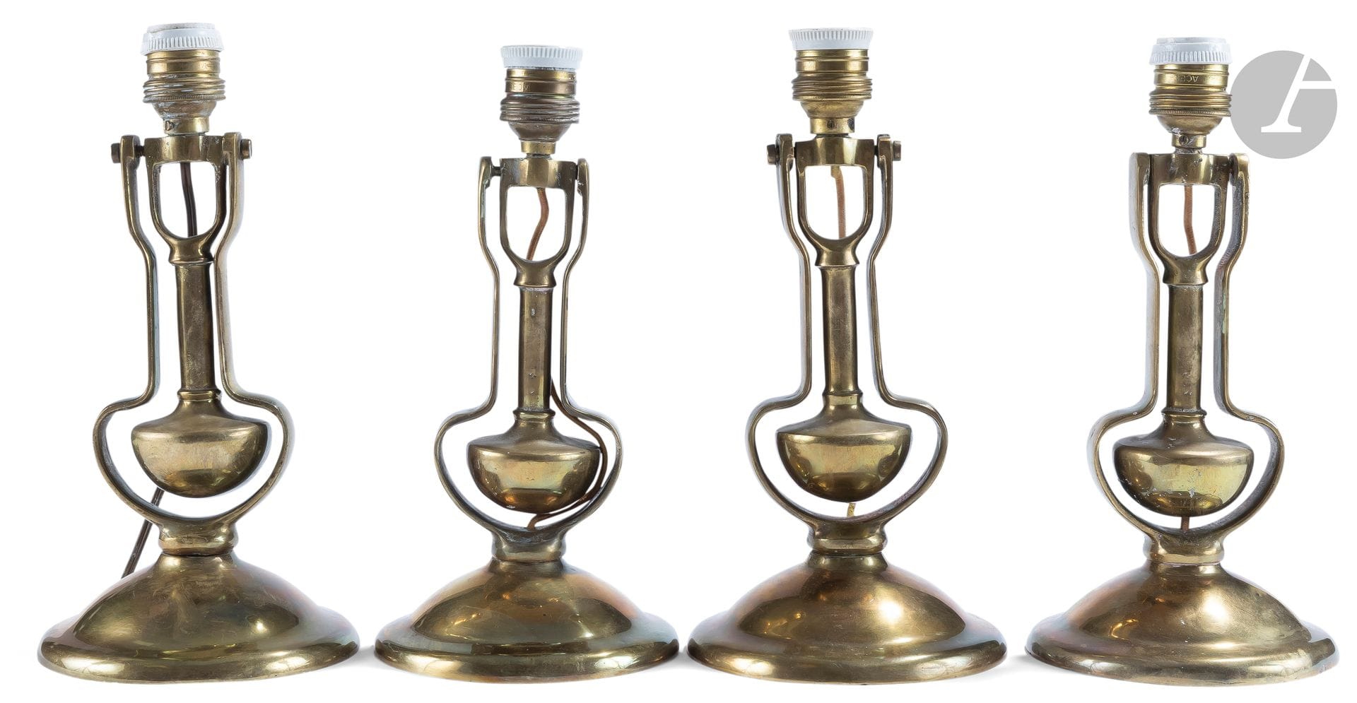 Suite of four polished bronze boat torches, the shaft tilting on an axis; (pierced for electricity); inscribed Kondu (on the reverse).
20th century.
H. : 28 cm