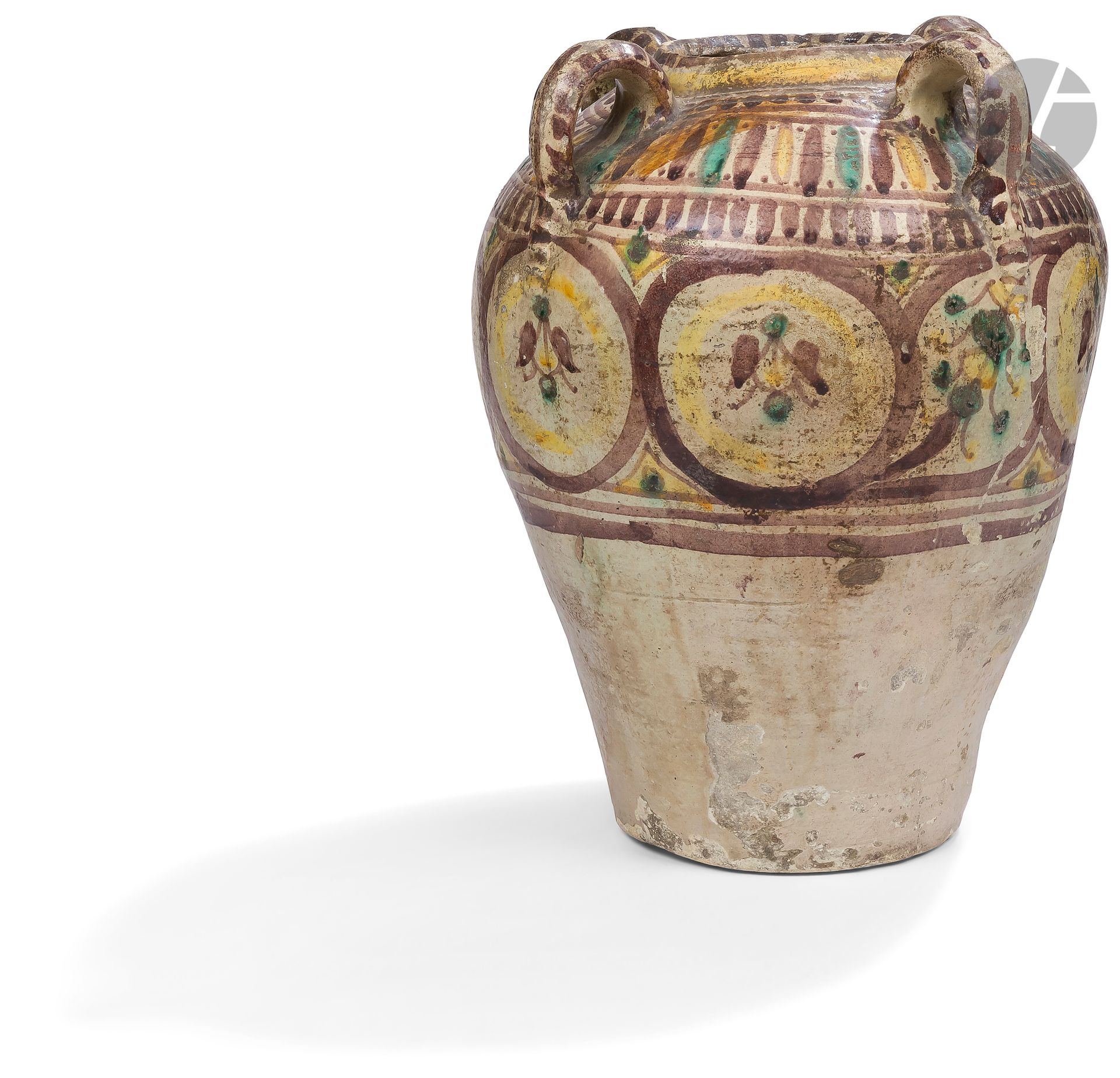 Large khabiyya jar with four handles, Tunisia, Tunis, Qallaline, late 18th - early 19th century
Jar with a high ovoid body surmounted by a small truncated conical neck and decorated with four curved handles on the shoulder. In earthenware with painted decoration of a frieze of roundels on the upper part of the body, friezes of vertical stripes or spindles on the shoulder, the neck and handles at the base stamped with a finger.
Height : 44 cm
Chips, reattached breaks, missing neck and some handles, traces of brown paint.

A Large Pottery Jug Khabiyya with Four Handles, Tunisia, Tunis, Qallalin, late 18th - early 19th century 

Traditional Qallalin ceramics (lots 180 to 188) - Samuel Hedri Collection (lots 174 to 212).