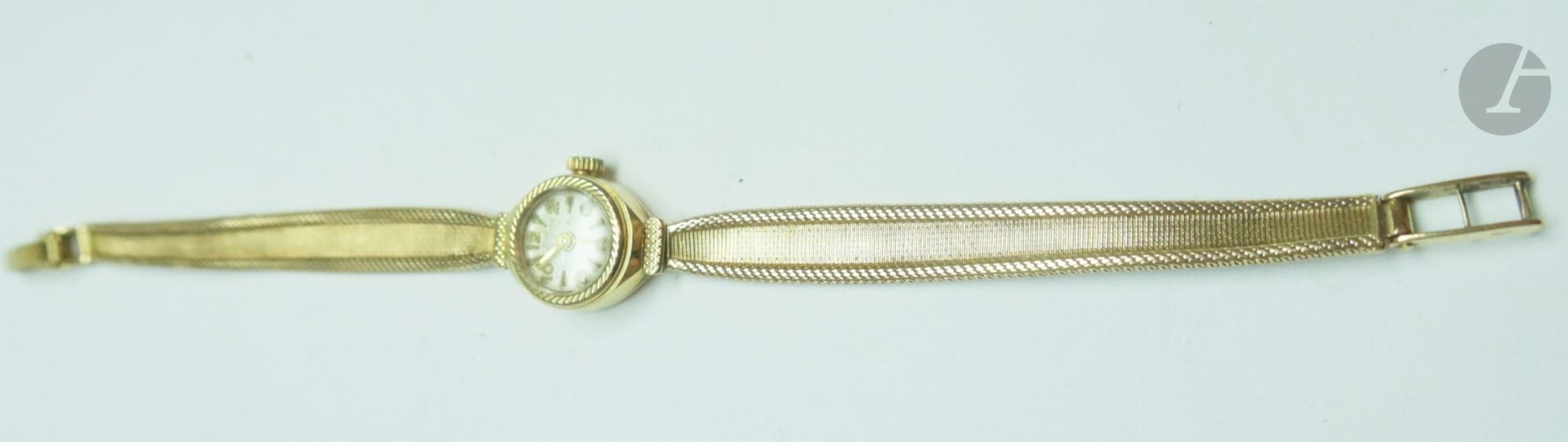 Montre bracelet de dame, ronde en or (18K). Bracelet souple en or. Poids brut : 17,1 g