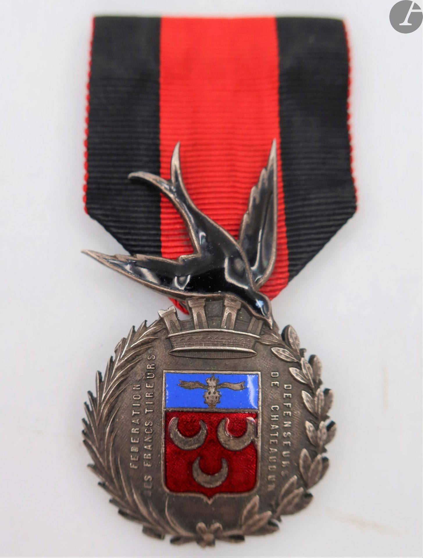 FRANCE 
MÉDAILLE DE LA FÉDÉRATION DES FRANCS-TIREURS DÉFENSEURS DE CHÂTEAUDUN (1870) – L’HIRONDELLE DE CHÂTEAUDUN. 
Rare médaille en métal argenté et émaillé (infimes éclats). Ruban avec épingle cousue. 
55 x 31 mm
T.T.B.