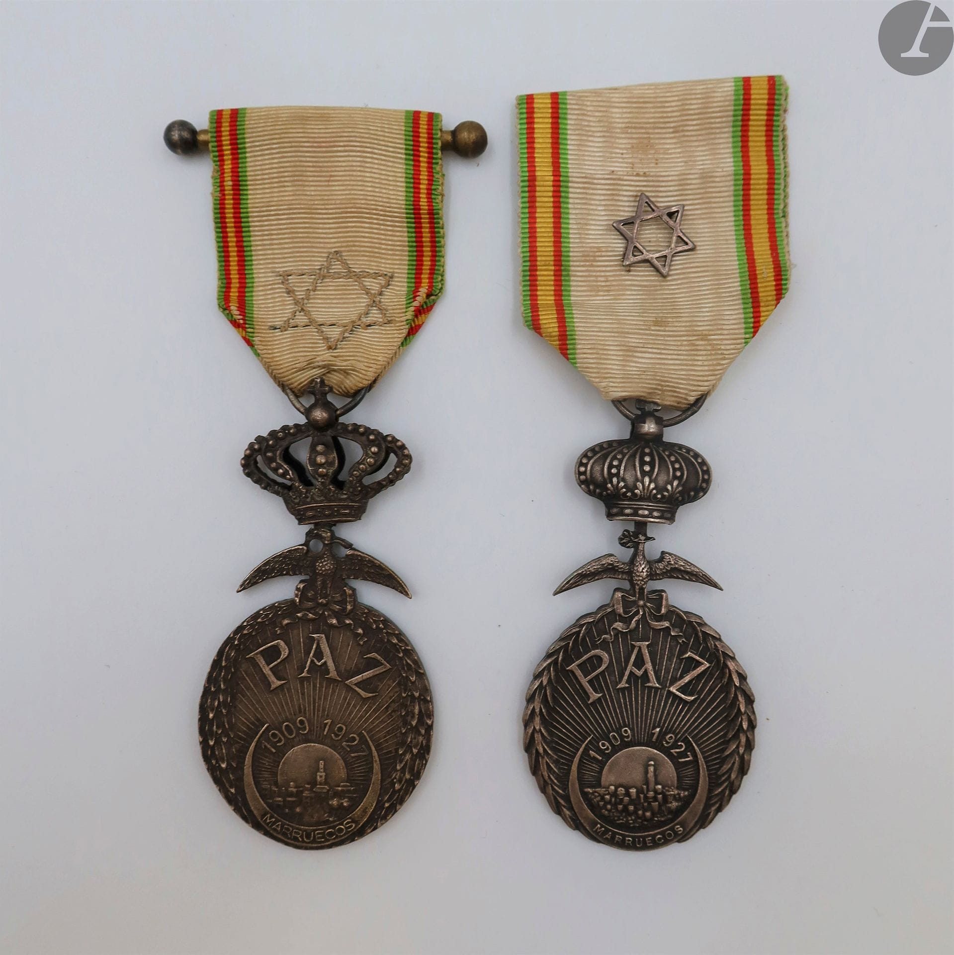 ESPAGNE 
MÉDAILLE DE LA PAIX DU MAROC (1927)
Deux médailles en bronze argenté. Deux modèles : 
- à couronne pleine. Ruban à motif à la croix chérifienne.
- à couronne ajourée. Ruban brodé à la croix chérifienne.
63 x 31 mm
T.T.B. à SUP.