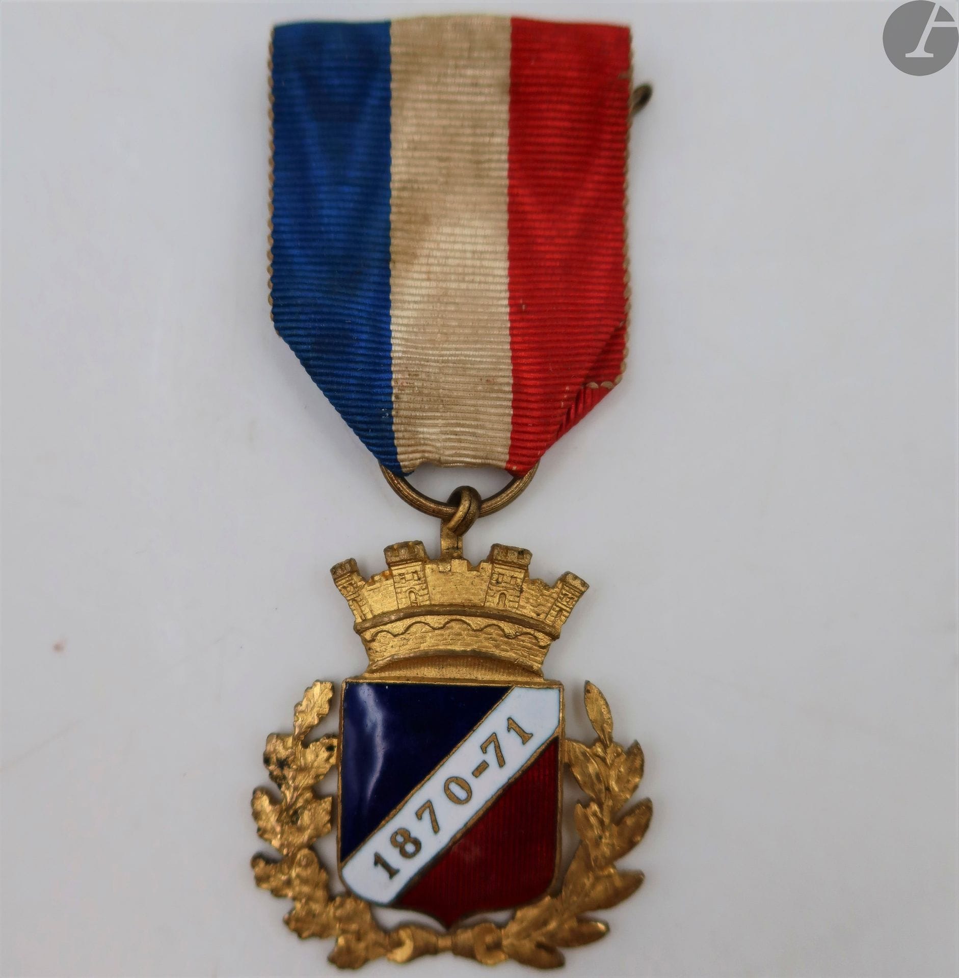 FRANCE
INSIGNE DE MEMBRE ATTRIBUÉ À L’UNION FRATERNELLE DES MOBILES ET COMBATTANTS (1870-1871)
En métal doré et émaillé. Ruban à épingle d’attache cousue. 
32 x 30 mm
T.T.B.