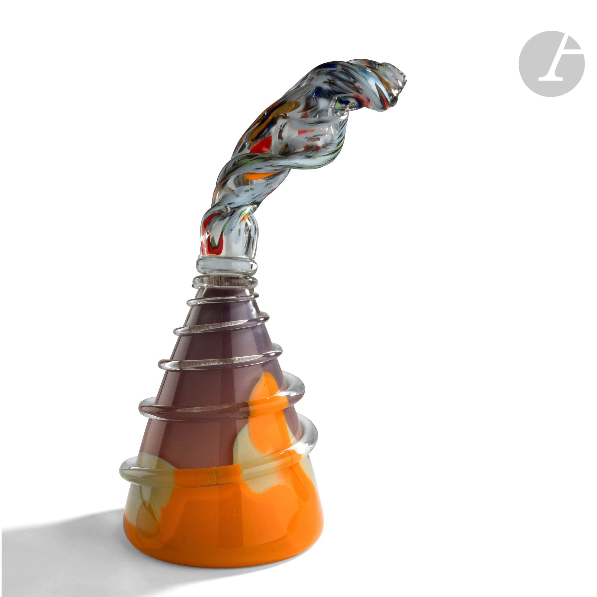 Anthony GUIBE (France, born 1940) 
Vulcano, 1990 
Glass bottle blown in orange and violet tones, surrounded by a transparent glass cord applied by heat, topped by an imposing stopper with polychrome decoration. This piece was made in Claude Morin's workshop "le Pontil" in Dieulefit, with the help of Killian Schurman. Signed and dated 1990 under the base. H. 43 cm - D. 18 cm 
Exhibition : Papier de verre - Salon d'Art contemporain de Rouen, July-August 1991, Galerie Complément d'Objet, Rouen
.

