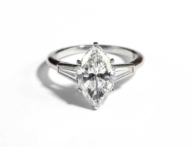 Bague en platine sertie d'un diamant navette pesant 2,58 cts, entre deux diamants trapèzes.
Signée CARTIER, Paris.
Poids brut : 4g
