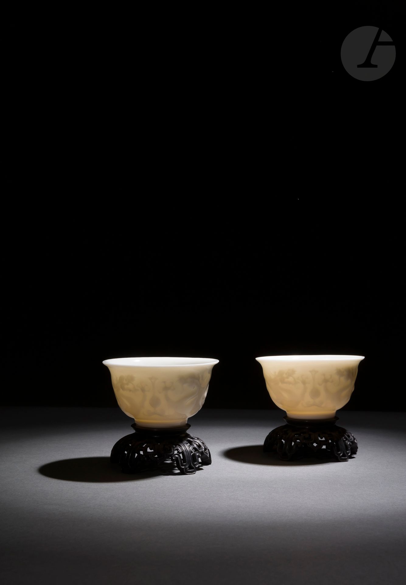 A pair of Dehua white porcelain wine goblets, China, 17th century
Of flared form, each with relief-molded decoration on the outside of two long four-clawed dragons in clouds facing each other around the flaming pearl. The interior, the reverse of the wing and the underside are covered with a beautiful ivory glaze. Unglazed heels. Wooden bases.
Height: 5.1 cm; diameter: 9.1 cm
In an orange box.

Provenance: 
E. T. Chow collection, n°476 (Sotheby's, 19 May 1981).

十七世纪 - 德化窑白釉模印双龙戏珠纹杯一对

Private collection from Paris - lots from 78 to 127, 219 and 220
