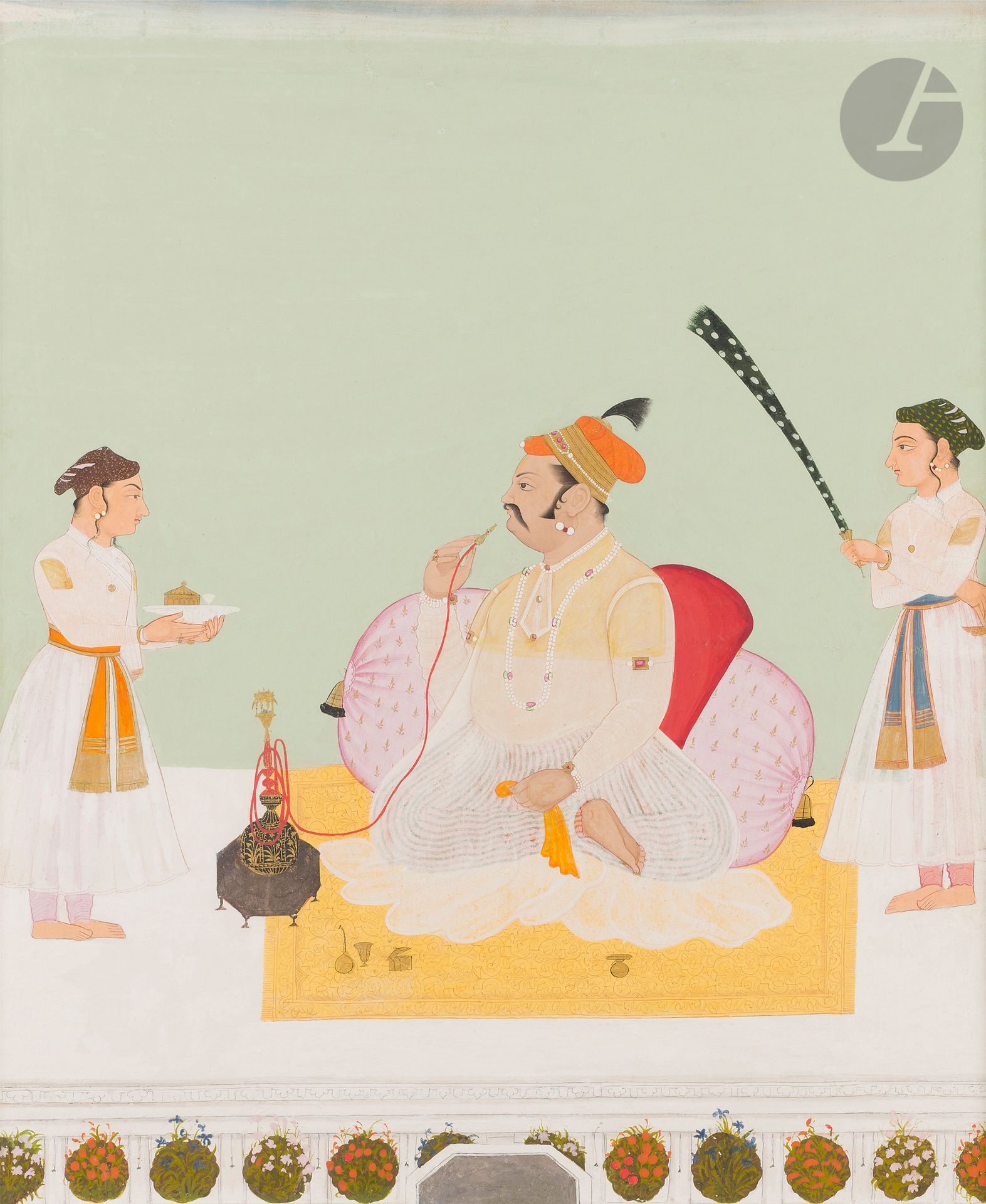 Portrait présumé du Maharana Udai Singh II de Mewar fumant la huqqa, Inde du Nord, Rajasthan, Mewar, XIXe siècle
Gouache et or sur papier représentant un homme assis en tailleur sur un tapis placé sur une terrasse bordée de parterres de fleurs et d’une fontaine. Adossé à deux coussins, il fume une huqqa placée devant lui. Il est coiffé d’un turban orange à galon doré, éléments orfévrés et aigrette et vêtu d’un jama blanc couvrant un pantalon rayé. De part et d’autre du raja reconnaissable à sa moustache et à son embonpoint, deux servants lui apportant des mets et l’éventant avec un chauri.
Dim. page : 51,4 x 42,7 cm ; dim. peinture : 46 x 37,5 cm

Udai Singh II fut Maharana de Mewar de 1540 à 1572. Il fut le fondateur de la capitale d’Udaipur bâtie entre 1559 et 1562 pour remplacer l’ancienne capitale de Chittor étant à l’époque fragilisée par la guerre civile et la cible de la dynastie afghane suri.

An Alleged Portrait of Raja Nar Singh Birhu, North India, Rajasthan, Mewar, 19th century