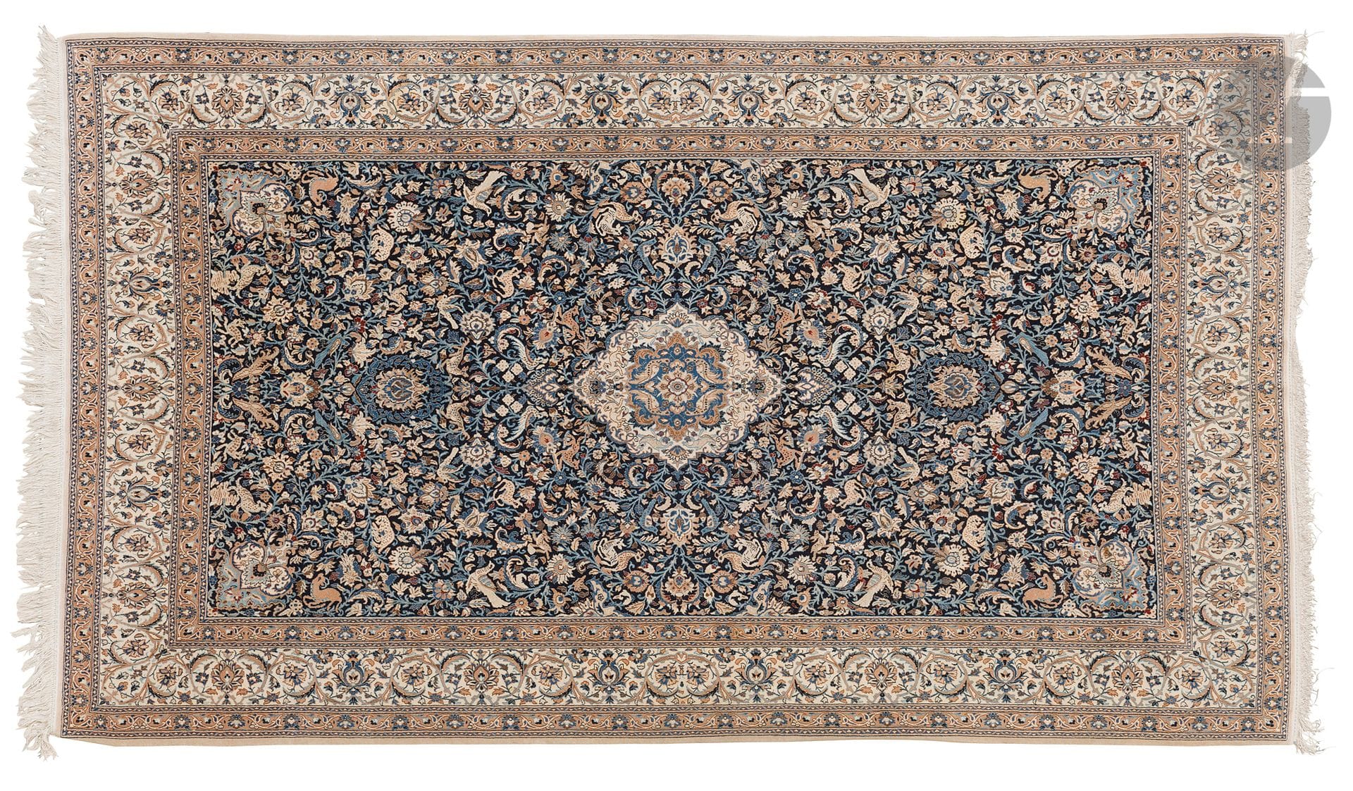 NAÏN, XXth century, wool and silk velvet (5%), cotton warps and wefts.
Carpet decorated with ivory medallions on a navy blue background scattered with floral scrolls, animals and birds, wide ivory border decorated with flowers. 
313 x 192 cm