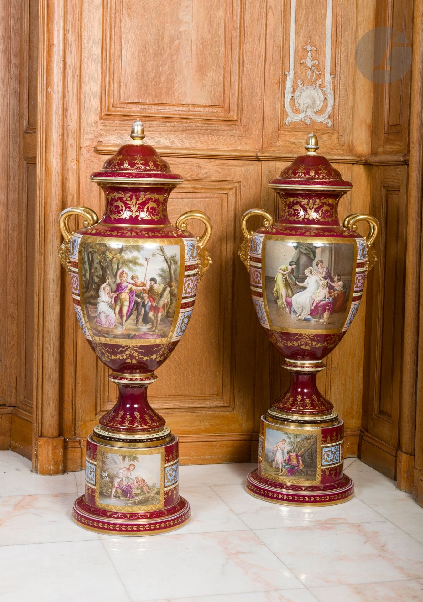 Vienne (genre de)
Paire de vases couverts en porcelaine à décor polychrome de scènes antiques dans des réserves sur fond rouge, les anses en forme de tête de satyre à fond or.
Fin du XIXe siècle.
H. 110 cm