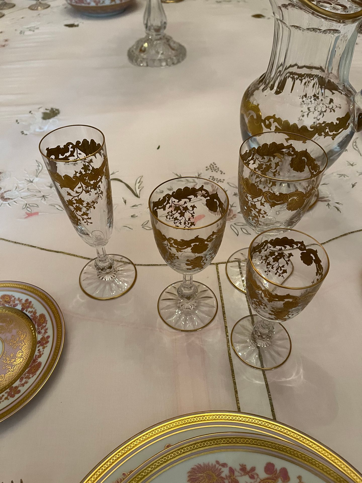 SAINT-LOUIS France.
Service de verres en cristal taillé et doré comprenant : 10 verres à eau (H : 16 cm), 20 verres à vin rouge (H : 14,5 cm), 20 verres à vin blanc (H 13 cm), 20 flûtes à champagne (H : 17,5 cm), 4 aiguières en cristal à décor gravé et doré de rinceaux et lions rugissant (H : 27 cm)