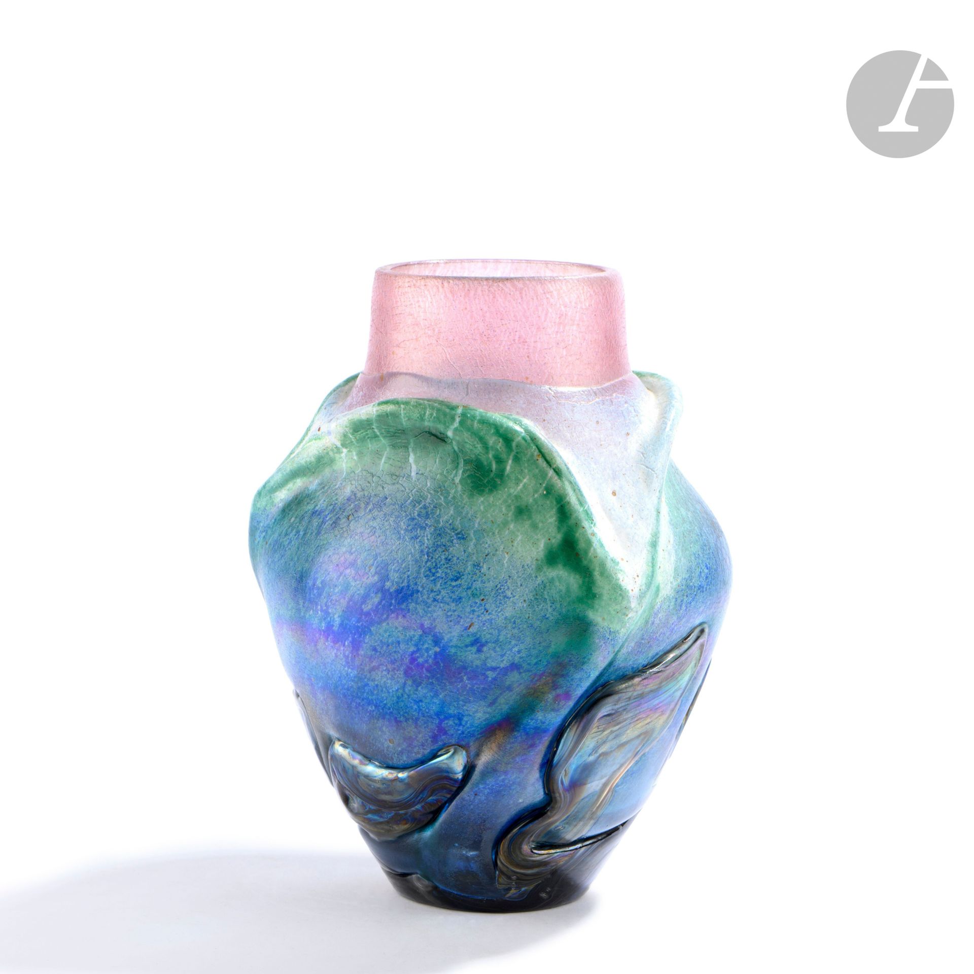 Jean-Claude NOVARO (France, 1943-2014)
Blown glass vase in blue, pink and green tones, decorated with handles in relief and iridescent color strings. Signed under the base and dated 1986. H. 20 cm - D. 15 cm. 

Provenance :
Galerie d'Amon, Paris.