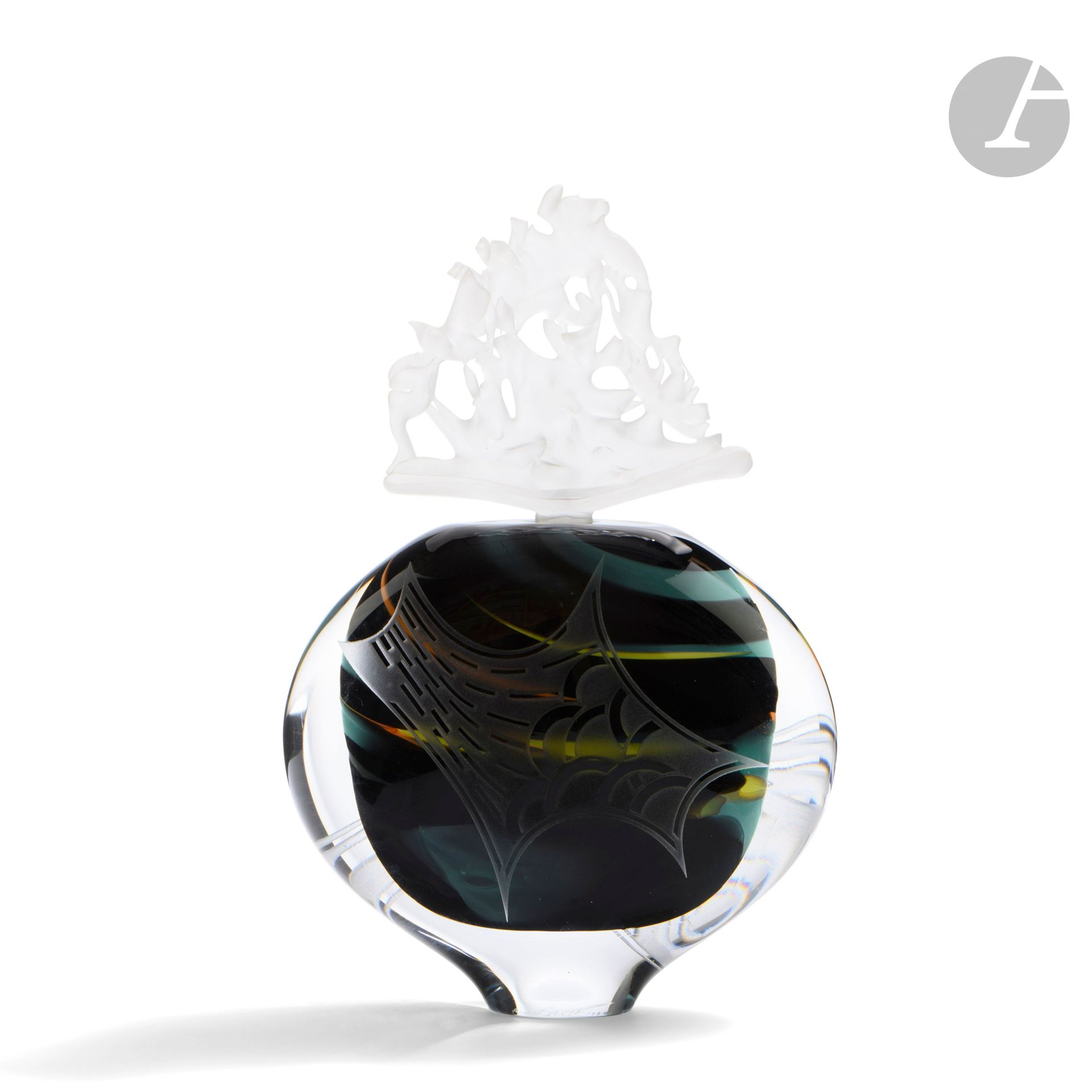 Régis and Gisèle FIEVET (France, born in 1948 and 1951)
Large bottle in black blown glass enhanced with green, orange and yellow, with sandblasted geometrical decoration, and its imposing flower-shaped stopper. Signed and dated 1990 on the base. H. 32 cm - W. 20 cm - D. 8 cm

Bibliography :
L'art du verre en France, 1985-2000: T. Baudry, A. and M. Bégou, R. and G. Fiévet - Exhibition catalog, Maison Ravier, Morestel, from June 17 to August 26, 2001. Reproduced in the catalog.