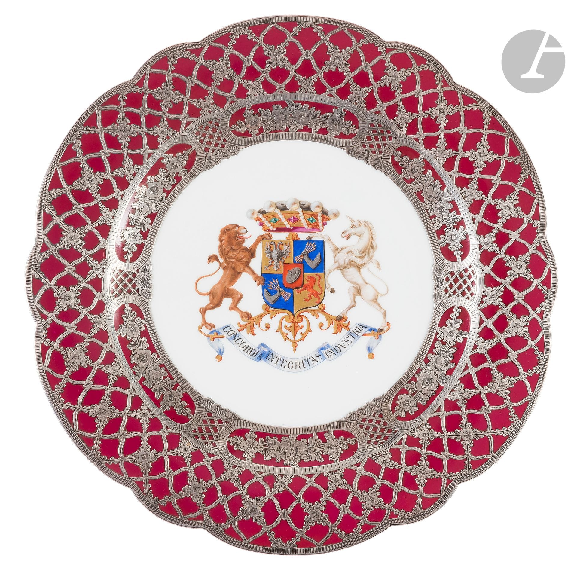[HENRI DE ROTHSCHILD - COLLECTIONNEUR]
SÈVRES, 1858
Rare assiette de présentation en porcelaine à décor appliqué en argent massif, AUX ARMES DES ROTHSCHILD au milieu du centre avec la devise ‘Concordia integritas industria’. Drapeau de fond violet avec placage d’argent floral
Porcelaine de la manufacture de Sèvres, 1858, la décoration effectuée en dehors de la Manufacture, 
Vert sous glaçure ‘S (18)58’, marques incisées. Une ligne de meulage. 
D : 25,6 cm
Probablement d’une série ayant appartenue à la baronne Nathaniel (Charlotte) de Rothschild, son hôtel particulier au 33 rue du Faubourg Saint-Honoré à Paris.