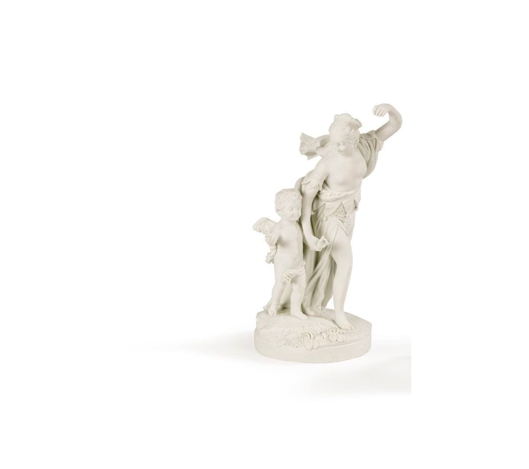 PARIS dans le goût de Sèvres
Groupe en biscuit de porcelaine représentant Vénus et l'Amour sur une terrasse circulaire.
Marque apocryphe de Sèvres deux L entrelacés en creux. Signé Boizot.
XIXe siècle.
H. 28 cm, D. 13 cm
Accident à l'une des figures (doigts manquants).