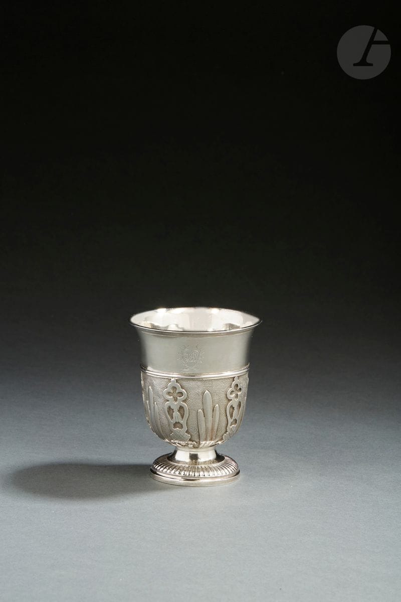 SAINT-MALO 1729 - 1743 OR PROVINCE
Silver tulip-shaped kettle with appliques. It rests on a pedestal chiseled with gadroons. The body is raised in median part of a rush of nets delimiting appliques of two sizes and models, alternating lanceolate leaves and lambrequins. The upper part of the body is engraved MS in a leafy interlace. 
Master goldsmith : attributed to Josselin HAMON, stamped in master abonné, received in 1729, crossed out in 1743
Weight : 124 g - height : 9,3 cm