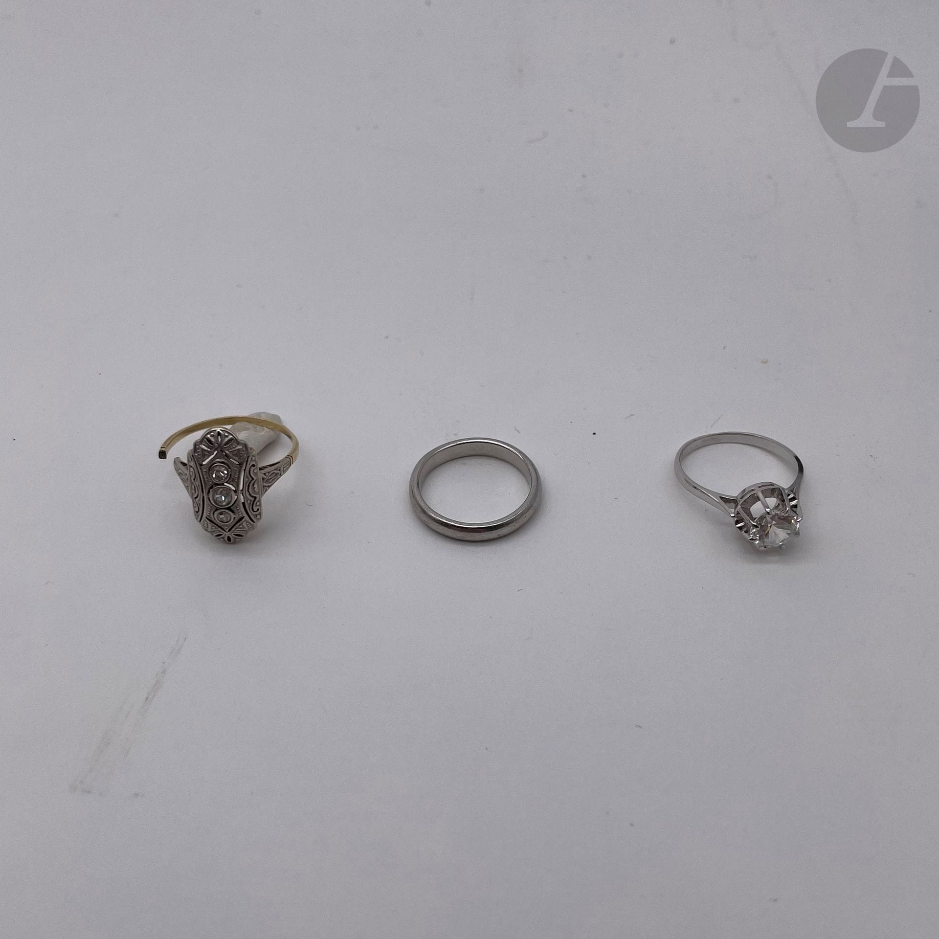 3 bagues, en or (14K et 18K) et platine:

- 1 bague en or (14K) et platine, petites pierres serties. (accident). Poids brut: 2,2 g

- 1 bague en or blanc  (18K) et pierre blanche (T 50). Poids brut: 2,6 g

- 1 alliance en platine (T 49). Poids: 2,2 g