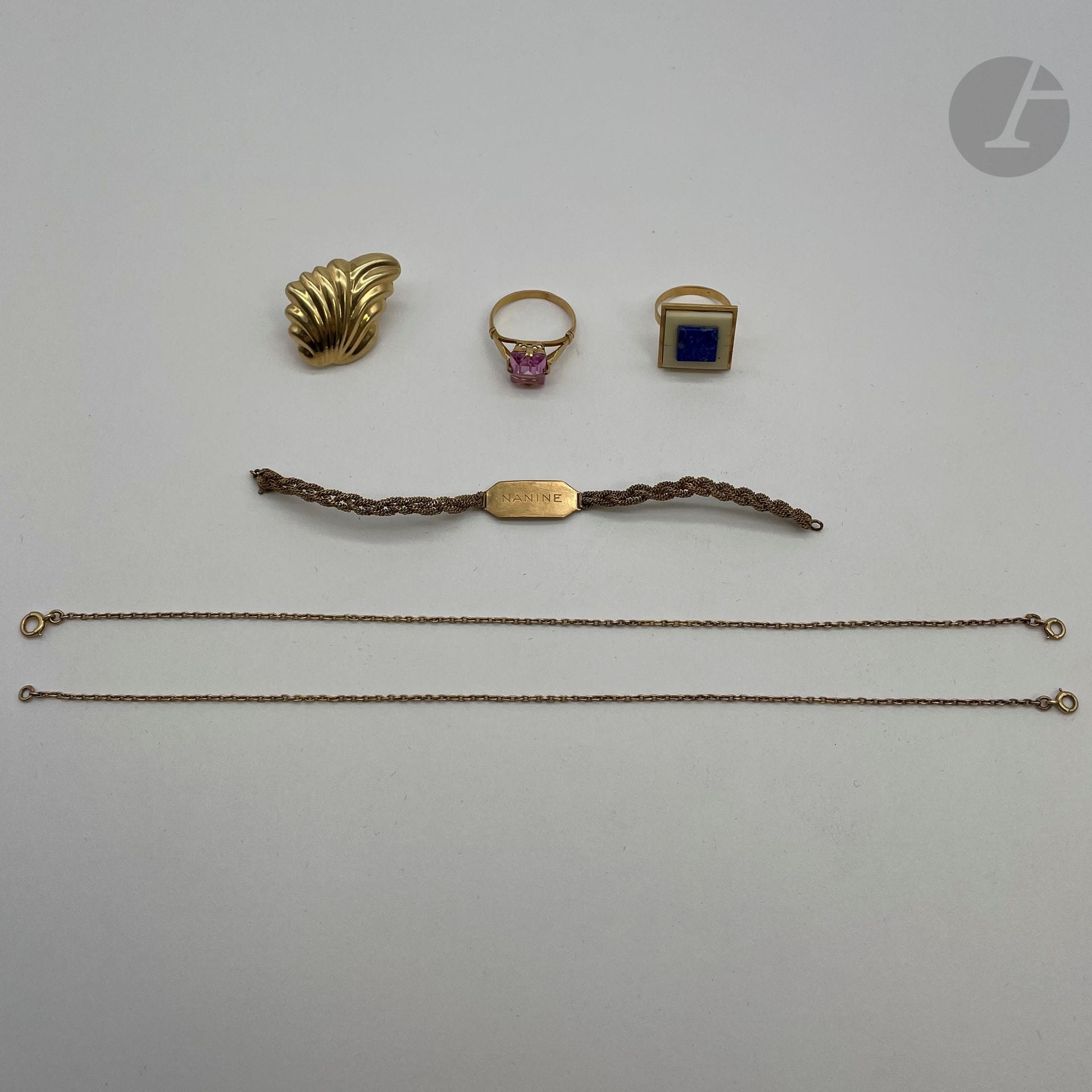 Lot de bijoux en or (18K). Poids brut: 16,2 g

- 1 gourmette d'enfant en or (18K). Poids: 4,6 g

- 2 chaines en or (18K)(longueur: 21 cm x 2). Poids : 3,6 g

- 1 bague en or (18K) et pierre rose rectangulaire. Poids brut: 3,7 g

- 1 bague en or (18K) et pierres dures serties. Poids brut: 4,3 g



On joint 1 boucle d'oreille en or (14K). Poids: 4,7 g