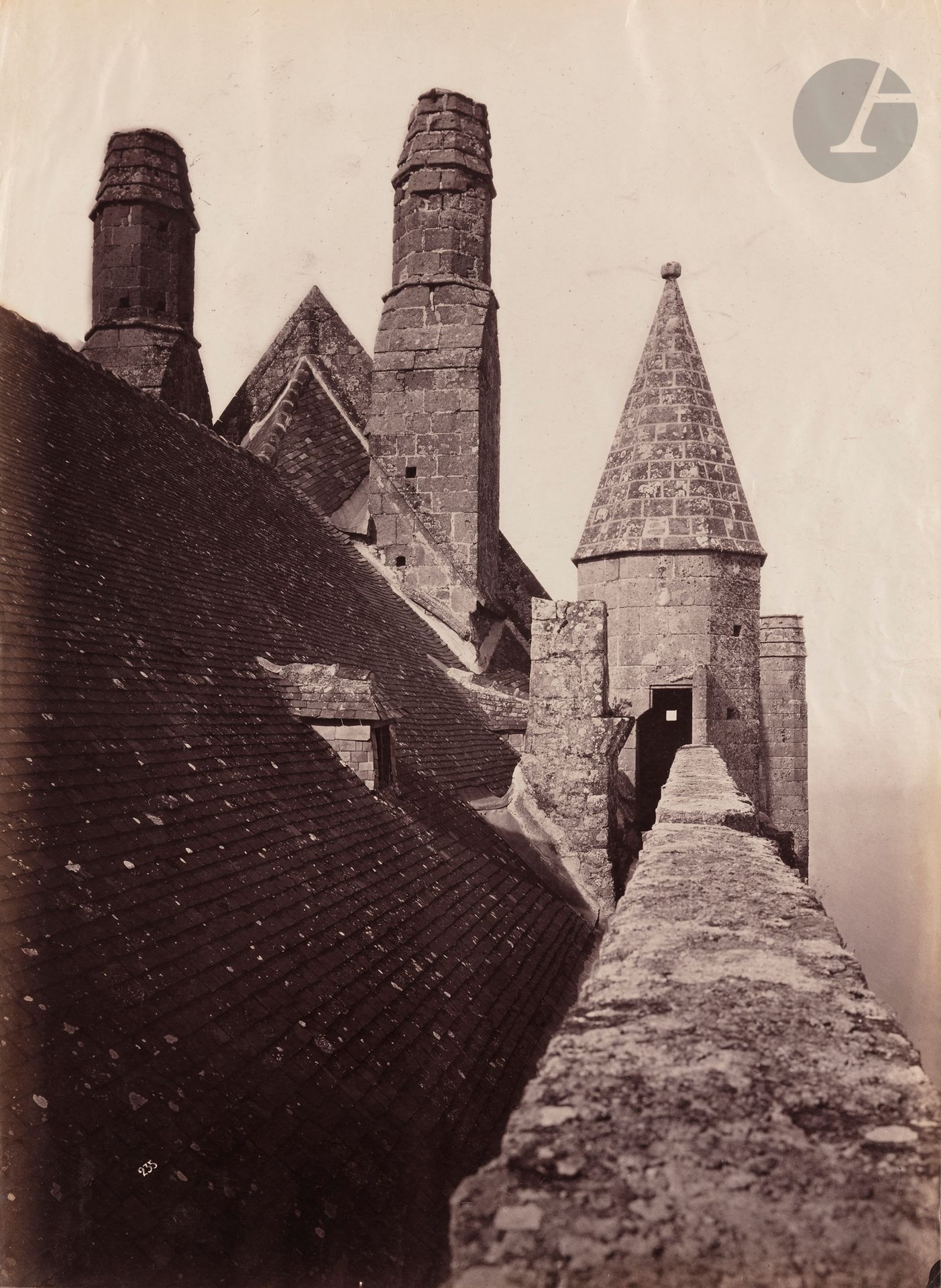 Louis-Émile Durandelle (1839-1917)
Photographic studies of Mont-Saint-Michel commissioned by Édouard Corroyer for restoration work, 1872-1880. 
General view. North tower &amp; bastion. Rampart. South fortification. Ruins of the Tour Claudine (entrance to the abbey). Bridge in the church courtyard. Cloister (north gallery). Cloister area and large west gable of the Dormitory. Abbey buildings (seen from the south-east ramparts). Front of the Merveille buildings (west). North transept and cloister. Abbey buildings (seen from the eastern ramparts). Church apse. General view (rocks to the northeast). Wonder. Knights' hall. Wonder. Dormitory. Promenade under the large platform to the west. Church. Nave. Second gate on boulevard site. Third king's gate. Rue du château. Saint-Aubert chapel. Entrance to the town. Restoration of the east gallery framework and view of the west facade of the Merveille. Reproductions of plans and sections. Reproduction of drawings by Édouard Corroyer. Model of the Merveille by Théodore Fouché.
In-folio album, accompanied by a page titled "Durandelle Photographe - Faubourg Montmartre", comprising 100 albumen prints from collodion glass negatives, mounted on sheets. Some handwritten annotations. Some negative numbers. 
Sizes: 18 x 24 to 31 x 48 cm

 In 1872, like Charles Garnier before him, architect Édouard Corroyer commissioned photographer Louis-Émile Durandelle to carry out a preliminary study for the restoration of Mont-Saint-Michel, and to document the various stages of the work. Both a medium and a witness to creation, photography was also a powerful communication and promotional tool that architects seized upon during this period. An ardent defender of the medium, Édouard Corroyer stated in 1883: "This way of presenting architectural works is the only good and practical one, because the photographic cliché and print become the sanction of the work".
