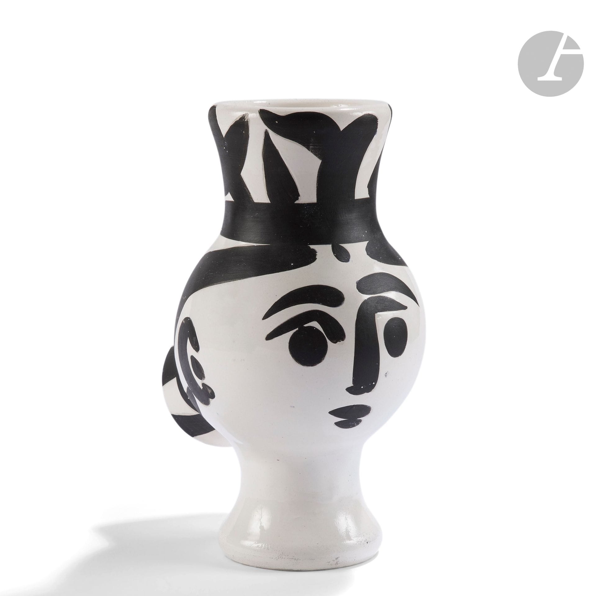PABLO PICASSO (1881-1973) & ATELIER MADOURA
Chouette femme, modèle créé en [1951]
Vase tourné.
Réplique authentique, éditée à cinq cents exemplaires réalisés chez Madoura.
Épreuve en terre de faïence blanche ; décor à l’engobe et paraffine, émail blanc, noir.
Marquée au pinceau Édition PICASSO- MADOURA sous la base à l’intérieur.
Hauteur : 28,5 cm

Bibliographie :
Alain Ramié - Picasso, catalogue de l’œuvre céramique édité 1947-1971 - Éditions Madoura, 1988. Modèle identique reproduit page 70 sous le numéro 119 du catalogue.
