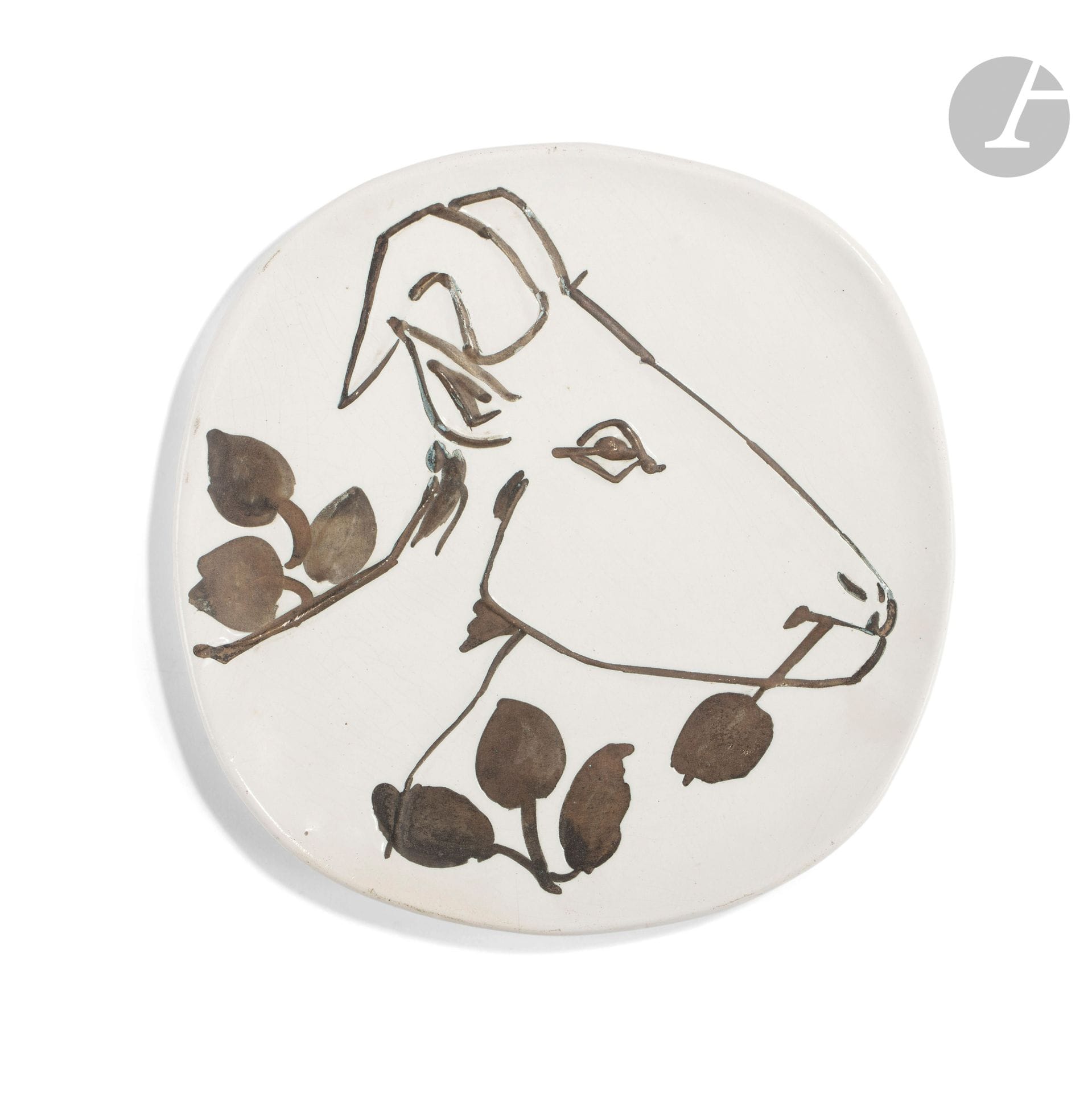 PABLO PICASSO (1881-1973) & ATELIER MADOURA
Tête de chèvre de profil, modèle créé en [1950]
Assiette ronde/carrée.
Empreinte originale, éditée à cinquante exemplaires réalisés chez Madoura.
Épreuve en terre de faïence blanche, décor à la paraffine oxydée et bain d’émail blanc ; bleu, vert.
Porte les cachets en creux Empreinte originale de PICASSO et MADOURA Plein Feu sous la base.
Diamètre : 25,5 cm

Bibliographie :
Alain Ramié - Picasso, catalogue de l’œuvre céramique édité 1947-1971 - Éditions Madoura, 1988. Modèle identique reproduit page 60 sous le numéro 107 du catalogue.