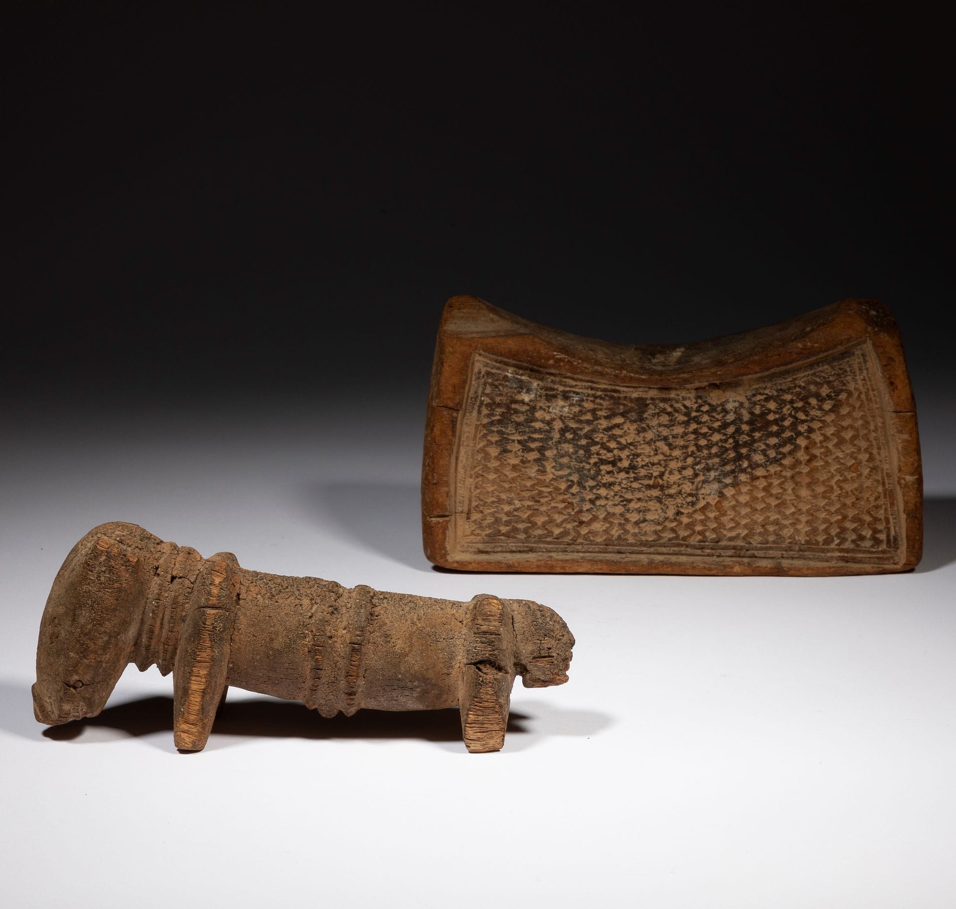 A lot gathering a very old and beautiful neck-rest of a rare model, the two sides entirely decorated with vertical zig-zag carvings, as well as an altar sculpture in the shape of a dog.

For another Dogon or Tellem neckrest (similar but with a different four-legged design), see : Supports de Rêves, Fondation Dapper, Éd. Dapper, 1989, p. 42.

Dogon or Tellem, Mali

Wood, burned, restoration on the neckrest (broken and glued), original piece, accidents and old missing parts on the dog, very beautiful and old patina.

L. : 19 cm and 21, 5 cm

H. 11 cm



Provenance :

Collection Nadine Vinot-Postry, Paris.