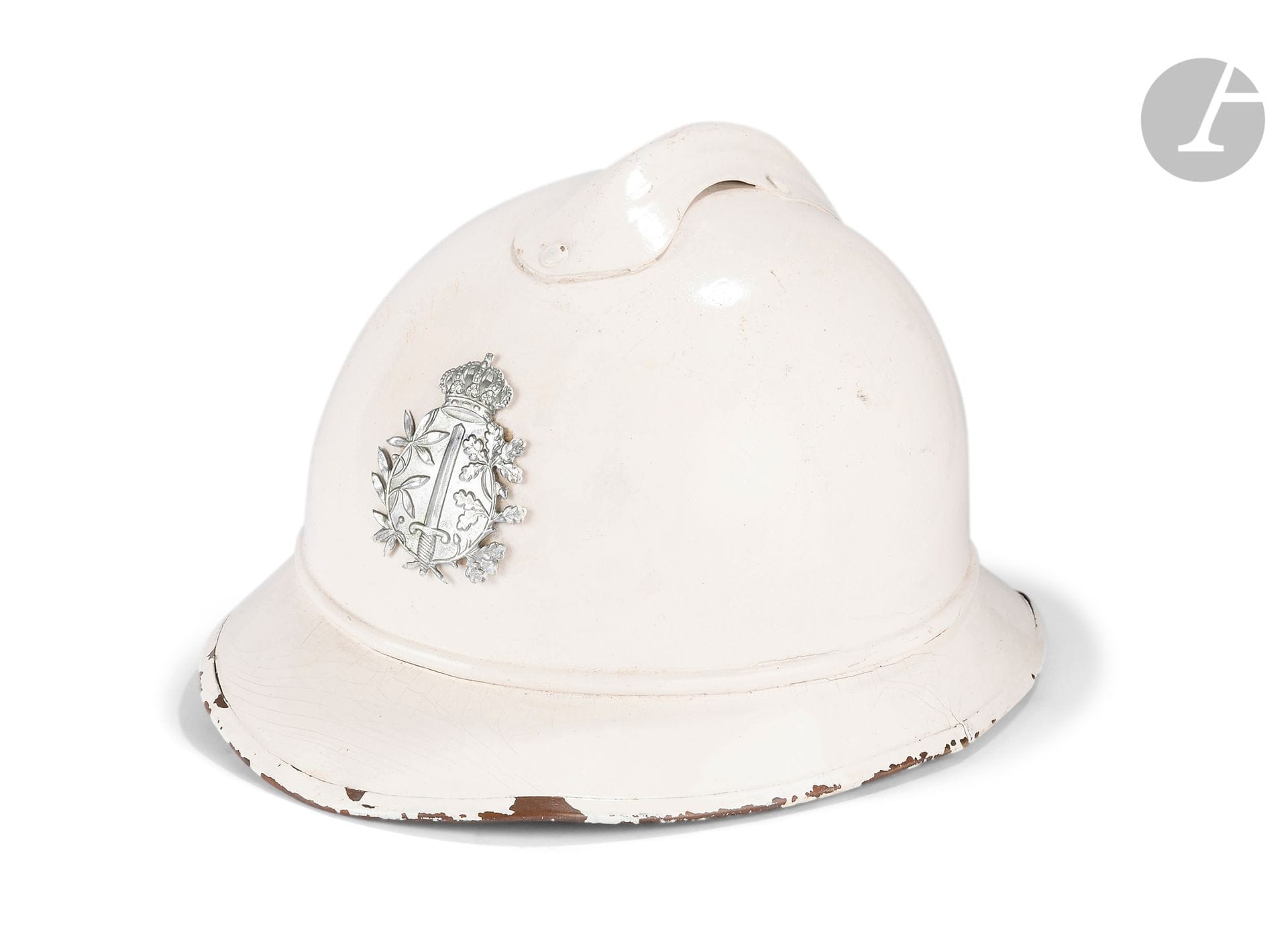 Belgian police helmet.
White painted light metal. Sword motif under crown. Brown leather chinstraps and cap with Maison Maréchal Brussels markings. 
Circa 1950.