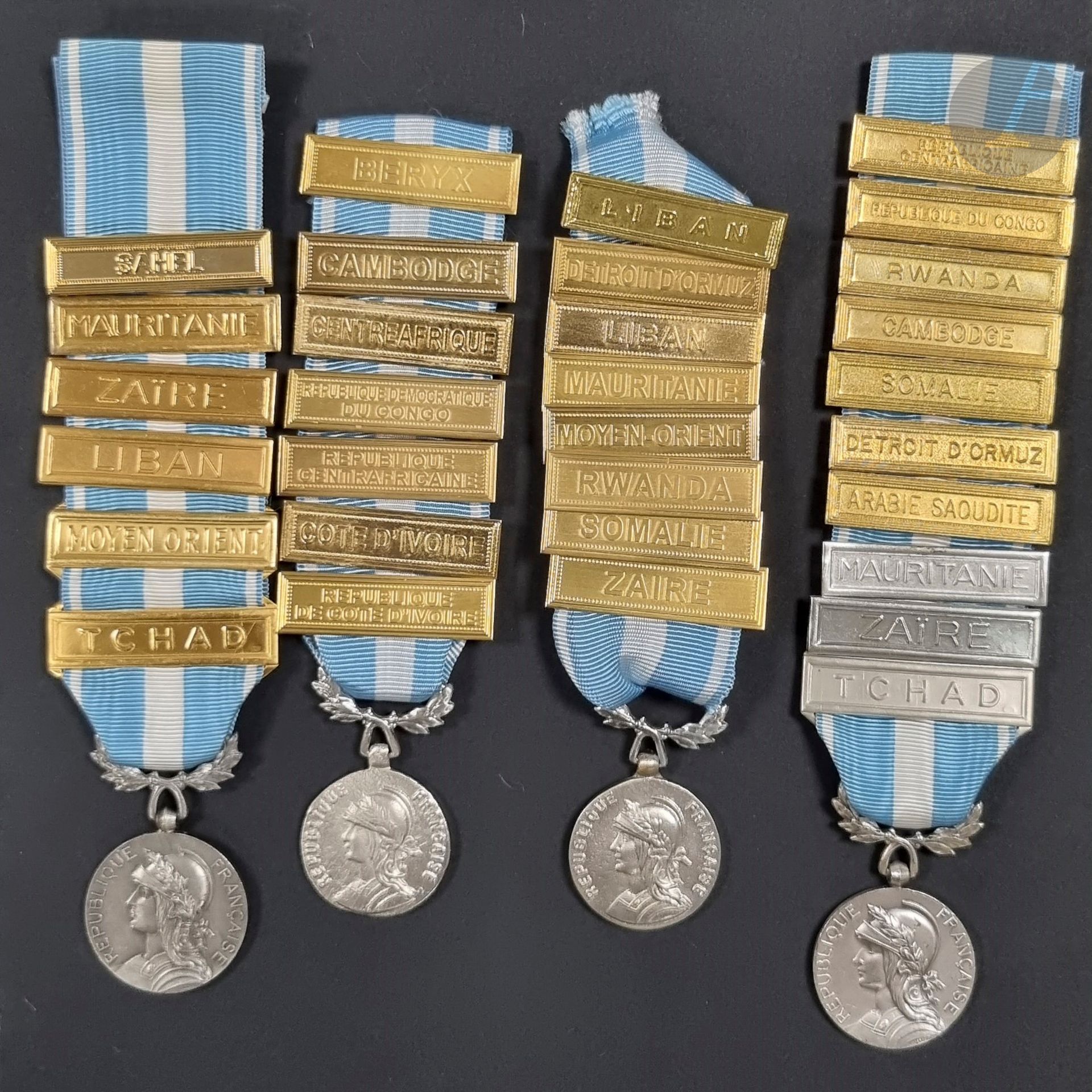FRANCE 
OVERSEAS MEDAL
Nice set of four overseas medals (two made by the Monnaie de Paris in hallmarked silver), and 31 clasps. 
Clasps " SAHEL ", " MAURITANIA ", " Zaire ", " Lebanon ", " Zaire 
"ZAIRE", "LEBANON", "MIDDLE EAST", "CHAD", "BERYX", "CAMBODIA", "CENTRAZFRIQUE", "REPUBLIQUE DEMOCRATIQUE DU CONGO", "REPUBLIQUE CENTRAFRICAINE", "COTE D'IVOIRE", 
"REPUBLIQUE COTE D'IVOIRE", 
"REPUBLIC OF THE CONGO", "RWANDA", 
"SOMALIA", "STRAIT OF ORMUZ", "SAUDI ARABIA". 
Different young manufacture (Monnaie de Paris, Lebanon), some silver bars.
Gross weight : 19 and 21 g
T.T.B. to SUP.
