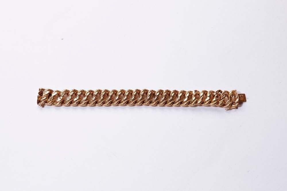 Bracelet en or 18K (750) creux, à maille gourmette américaine. Longueur : 18 cm environ. Poids : 25 g