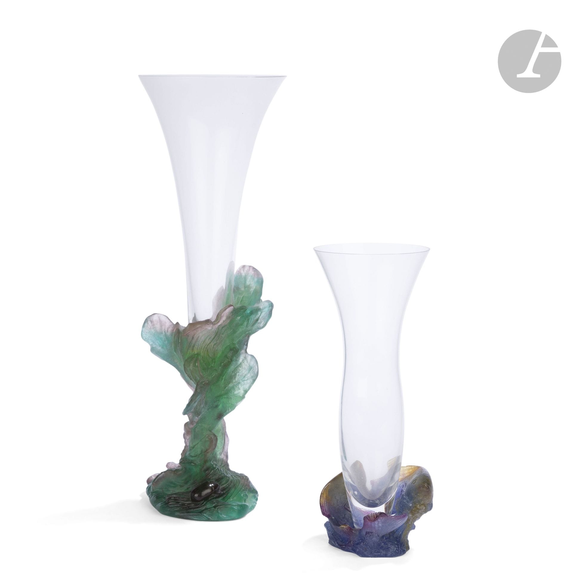 DAUM FRANCE - 2 WORKS
- Pisces
Horn-shaped vase. The base with title motif in polychrome pâte de cristal. The cornet in clear crystal. Marked DAUM France under the base. H. 22,5 cm
- Beetle in salad leaves
Horn vase. The base with title motif in polychrome pâte de cristal. The cornet in clear crystal. Marked DAUM France and numbered (illegible) under the base. H. 34.5 cm