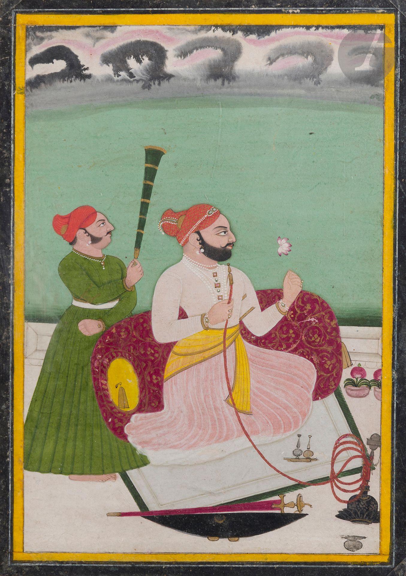 Portrait présumé de Madho Singh fumant la huqqah, Inde du Nord, Rajasthan, probablement Bundi, début XIXe siècle
Gouache sur papier rehaussée d’or, représentant le raja agenouillé, adossé contre un gros coussin, le regard tourné vers la droite. Il tient une fleur de lotus dans la main gauche, le tuyau de sa pipe à eau huqqah dans la main droite, son sabre talwar et son bouclier posés au sol à côté de lui. Derrière lui, un suivant l’évente avec un chasse-mouches morchal. Au revers, ligne de nagari donnant le nom de Madov Singh, tampon des collections du Maharaja de Bikaner, et nom calligraphié à l’encre de Khet Singh.
22,2 x 15,6 cm
Quelques sauts de polychromie et repeints, encadrements jaune et noir ajoutés.

A Presumed Portrait of Madho Singh Smoking a Hookah, North India, Rajasthan, probably Bundi, early 19th Century
