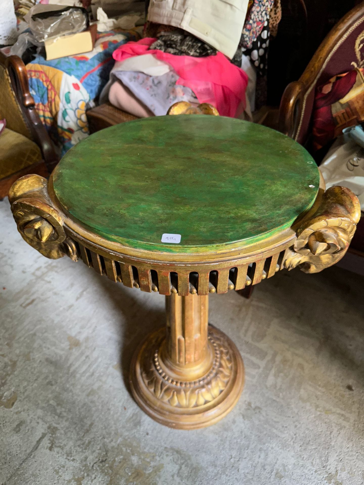 Small pedestal table in moulded and carved wood, the belt decorated with three ram heads. 65 x 47 cm