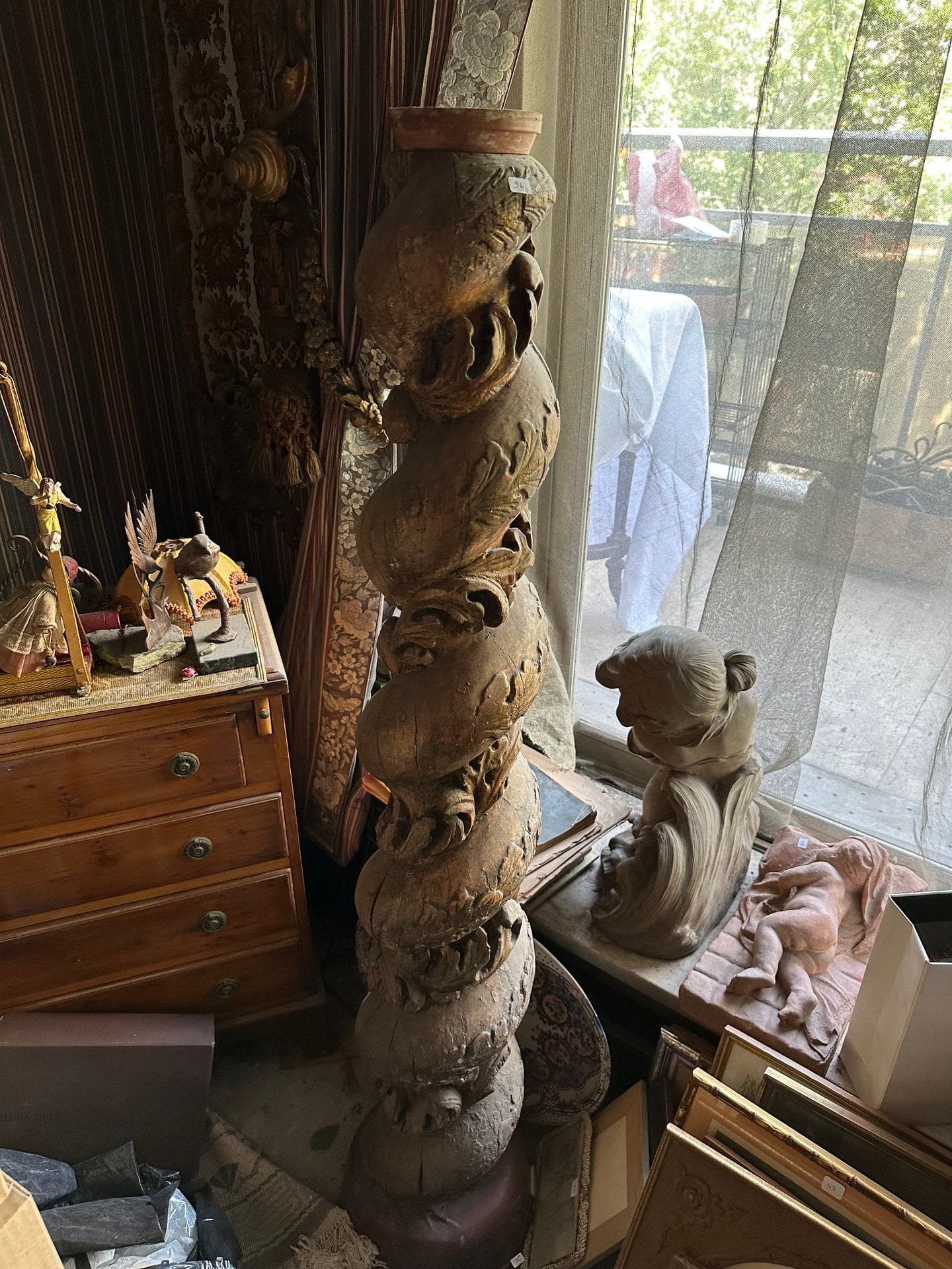 Pair of torso columns in molded and carved wood, decorated with foliage.