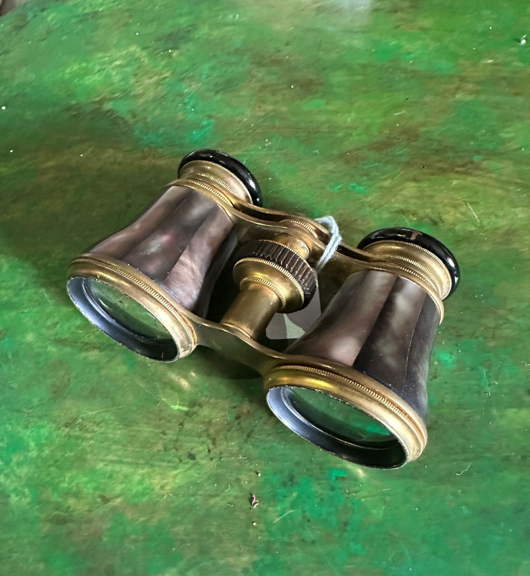 V. VICTORINE HANOVER
Brass theater binoculars with mother-of-pearl plates.
gilded metal folding glasses attached.