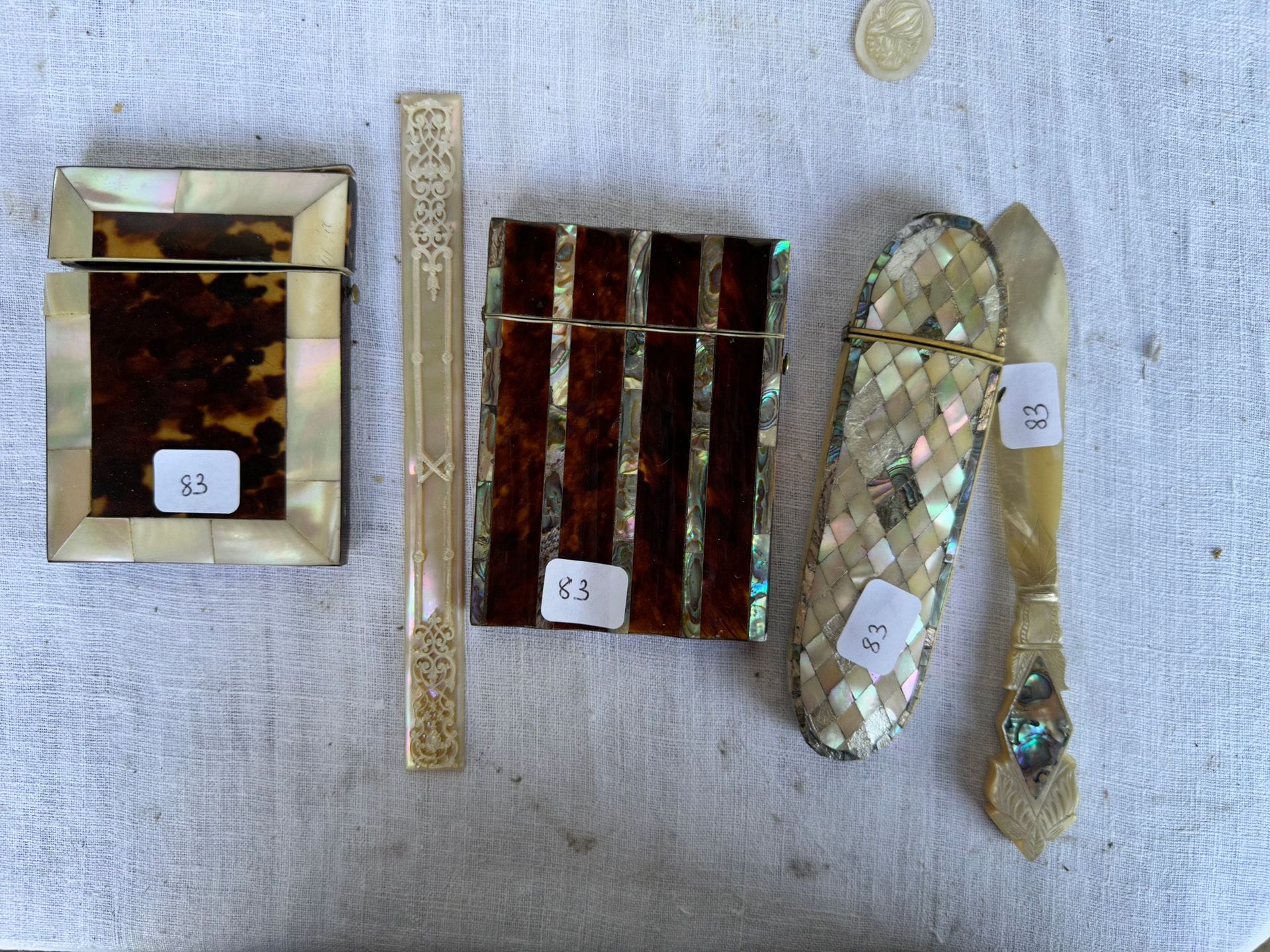 Lot de 3 étuis et un coupe papier en nacre, en écaille et à l'imitation de l'écaille.