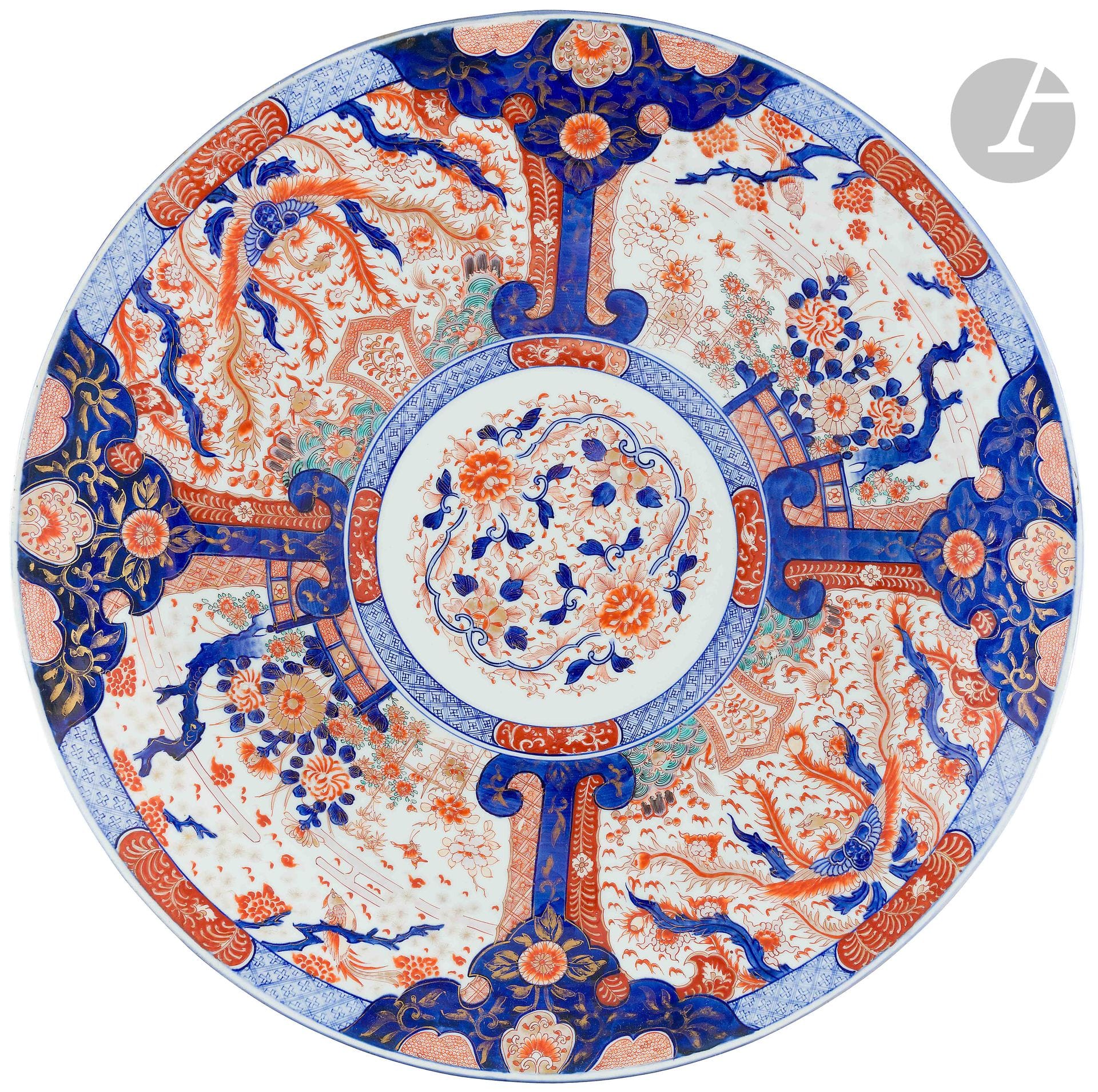 Japan 
Large round porcelain bowl with blue, red and gold Imari decoration in the center of flowering scrolls in a medallion framed by phoenixes and flowers in reserves. 
19th century.  
L. 56 cm.