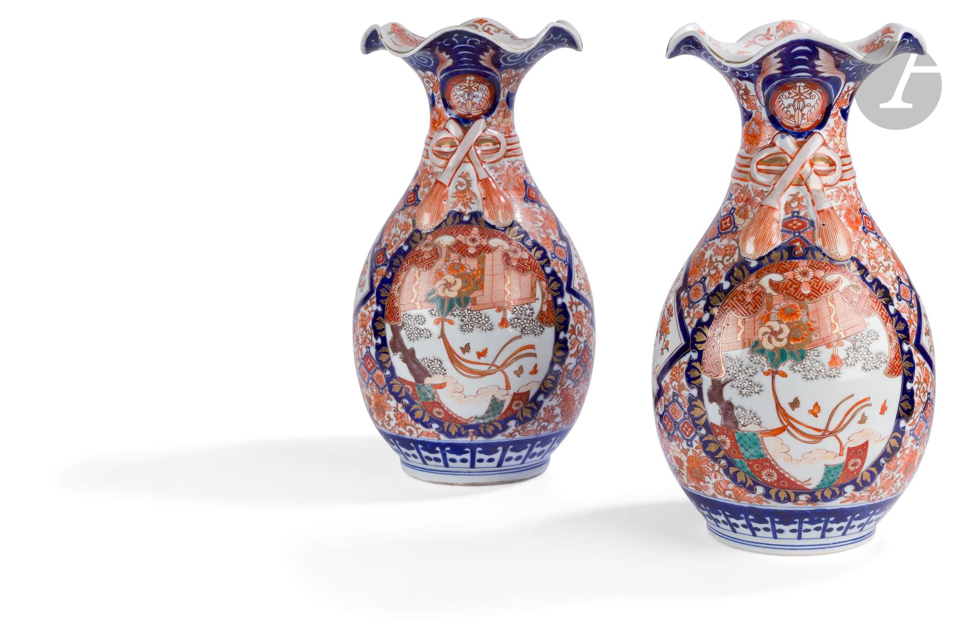 Japan  
A pair of baluster vases and an ovoid planter, with wavy necks, in porcelain with blue, red and gold Imari decoration of gardens, flowers, ribbons, birds and foliage. 
19th century. 
H. 38 cm and 25 cm.