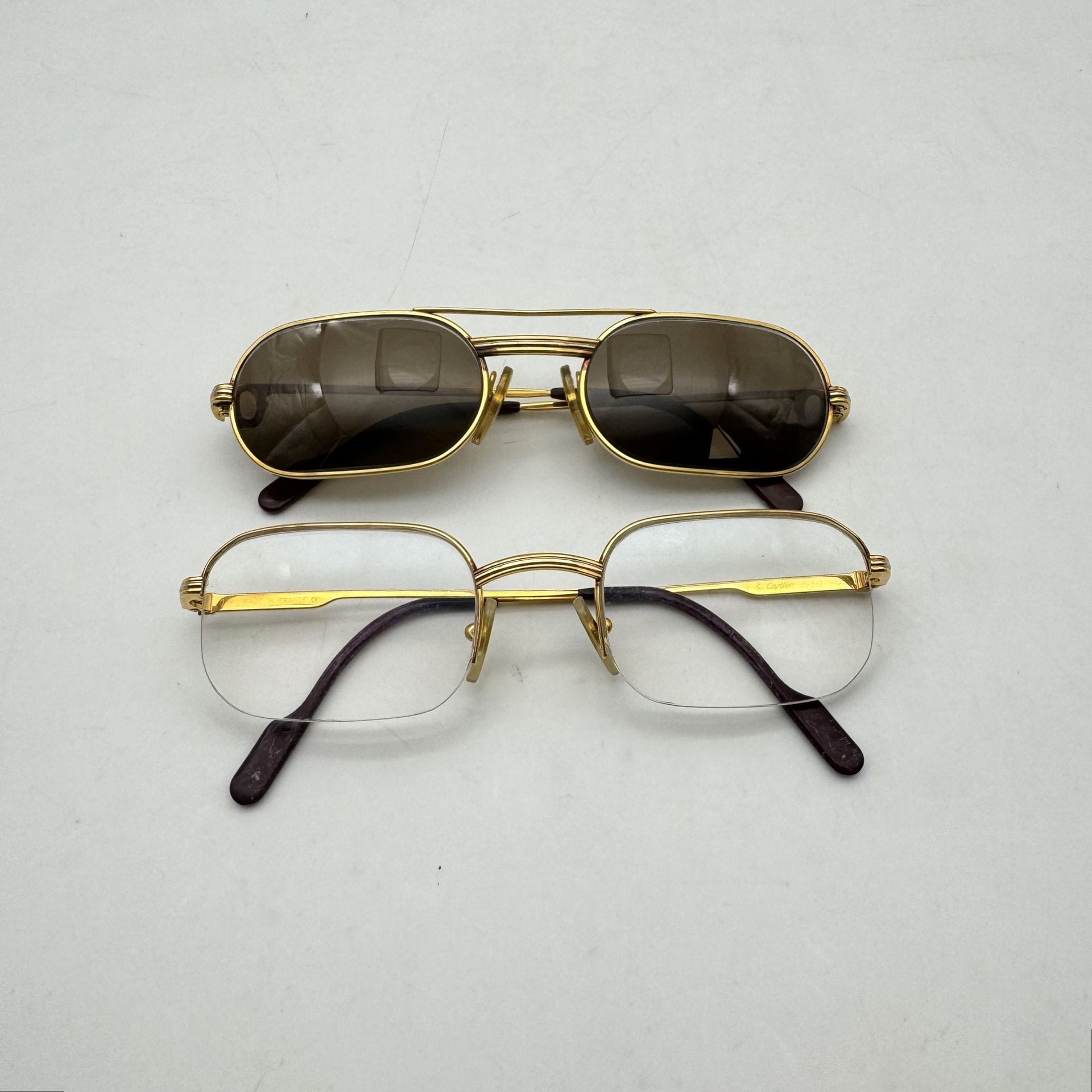 Cartier
Two pairs of glasses: one prescription and one sunglasses (scratches, as is)
