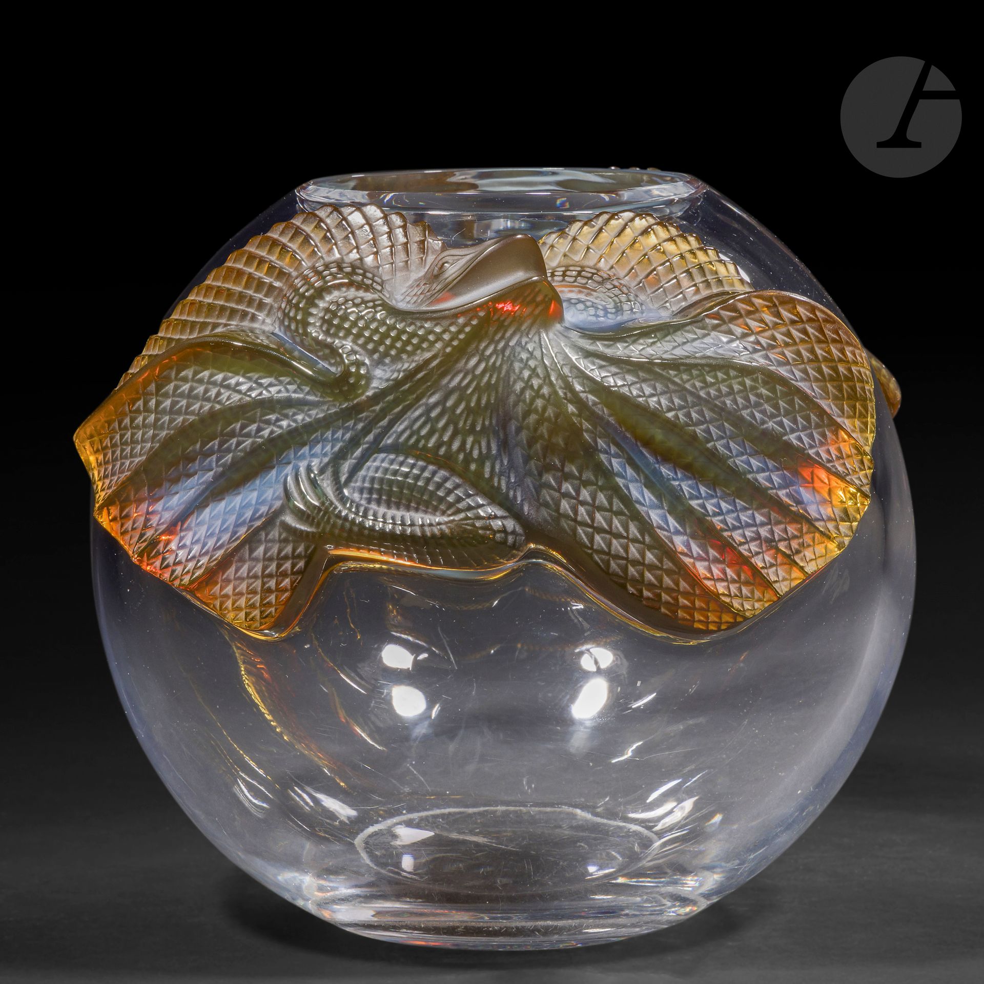 MARIE-CLAUDE LALIQUE (1935-2003) – MAISON LALIQUE
Erimaki, le modèle conçu en [1988]
Vase boule.
Épreuve en cristal soufflé-moulé, au décor en applications à chaud de lézards en cristal moulé-pressé teinté ambre dans la masse et satiné.
Infimes chocs et égrenures au décor de lézards.
Non signé.
Hauteur: 23 cm – Diamètre: 28 cm