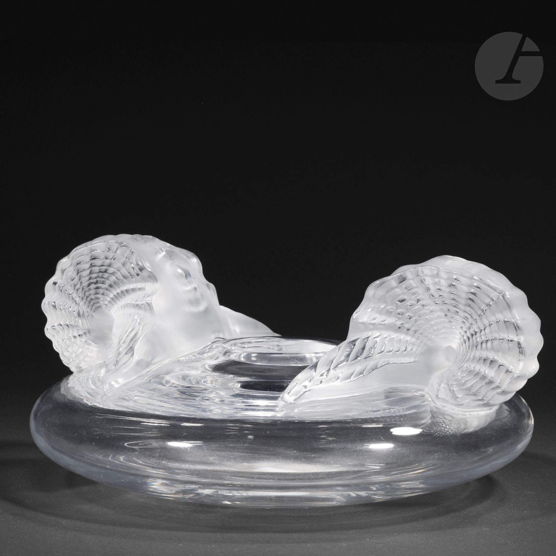 MARIE-CLAUDE LALIQUE (1935-2003) - MAISON LALIQUE
Santorin, the model designed in [1981].
Top-shaped vase with small annular neck and high-relief decoration.
Proof in blown-molded and molded-pressed crystal, partly satin-finished.
Minor scratches, notably under the base.  
Unsigned.
Height:13 cm - Diameter:30 cm