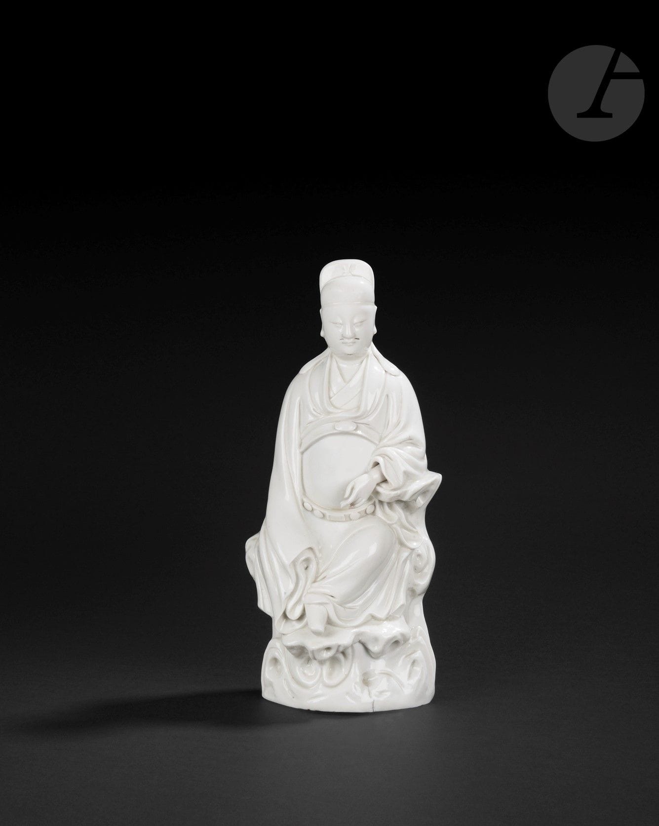 Chinese white porcelain Wenchang, China, Dehua, 17th century
The Taoist god of literature is depicted seated on a pierced rock, wearing a long belted robe and an official's headdress. The face is serene, pierced with small holes for a moustache and beard. The right arm rests on a rock, revealing the hand, while the left arm is entirely concealed in the sleeve. 
Height: 33.5 cm

Provenance: 
Michael B. Weisbrod INC, New-York" label.