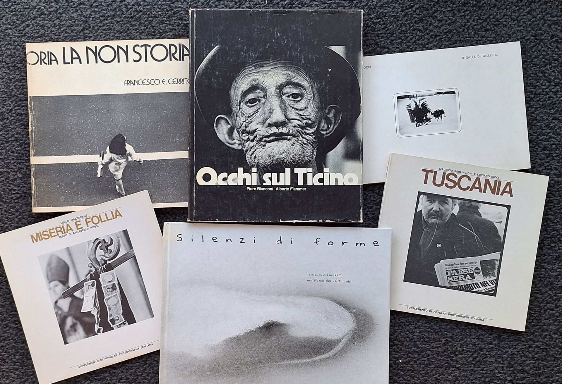 ITALIAN PHOTOGRAPHERS
6 books.
*Luca Gilli
Silenzi di forme - Fotografie di Luca Gilli nel Parco dei 100 Laghi
In-4 (27 x 29 cm). First edition. Text by Georges Vercheral. 55 black and white photographs. Illustrated boards.
*Piero Bianconi / Alberto Flammer
Occhi sul Ticino.
Tipografia Stazione 1973 - Armando Dado editore
In-4 (26 x 24 cm). First edition. 88 photographs. Hardcover with dust jacket.
*Fulvio Rosso
Il gallo di Gallura - The cock of Gallura.
Giancarlo Politi Editore, 1976.
In-8 (17 x 24 cm). Original paperback edition. 
*Lello Mazzacane
Miseria e folia.
Supplemento di Popular Photography Italiana, 1971.
In-8 (20 x 20 cm). Original paperback edition. Text by Annabella Rossi.
*Maurizio Berlincioni and Luciano Ricci
Tuscania.
Supplemento di Popular Photography Italiana, 1971.
In-8 (20 x 20 cm). Original paperback edition. 
*Francesco E. Cerrito
La Non Storia.
Magma Editrice, Roma, 1975.
In-4 (22 x 22 cm). Original paperback edition. Introduction by Costanzo Costantini. Illustrated softcover.