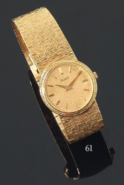 Montre-bracelet de dame, en or jaune, la montre de forme ronde, mouvement mécanique, tour de poignet articulé amati. PIAGET. Longueur : 16 c.m Poids brut : 57 g.