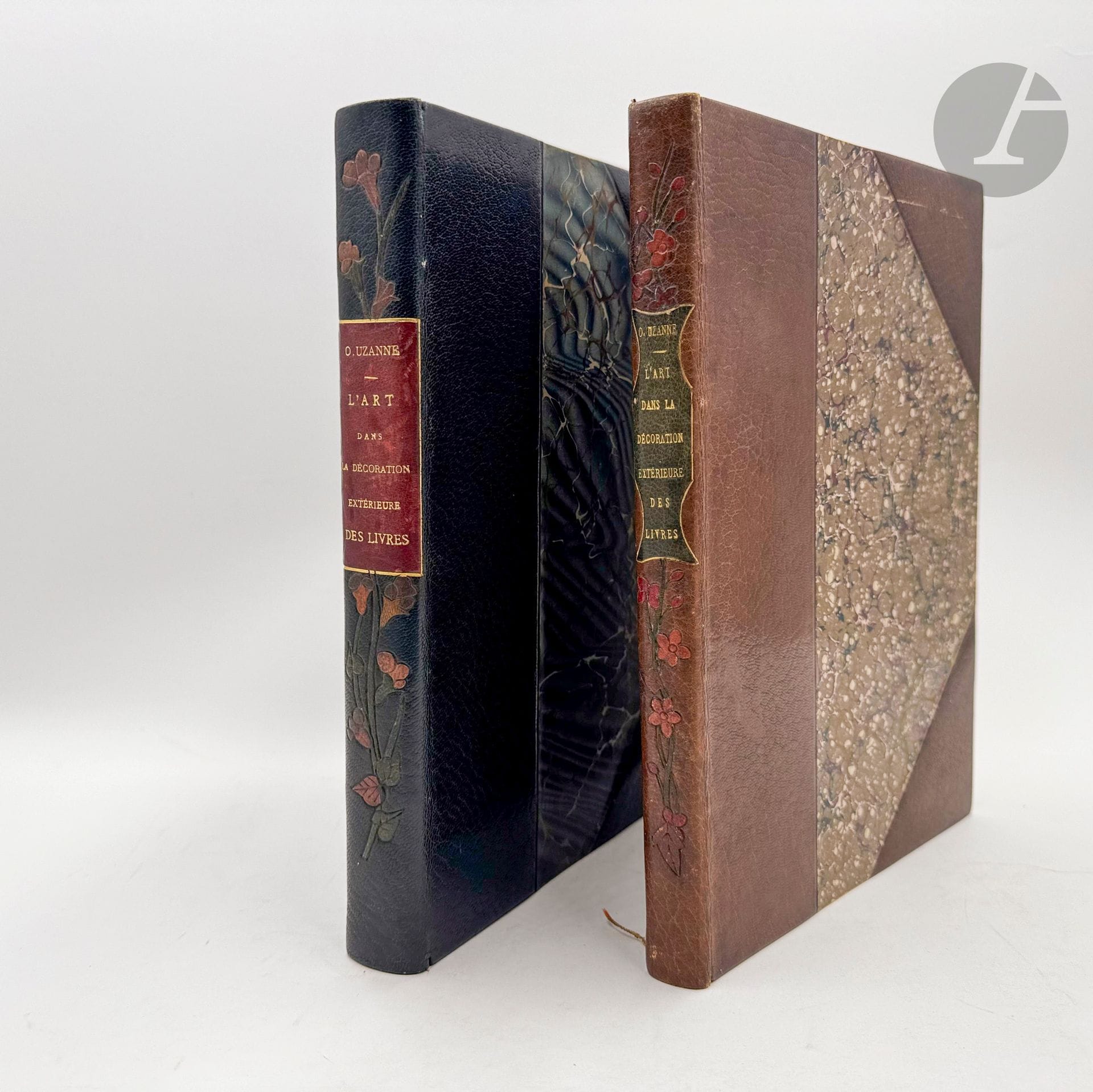 UZANNE (Octave).
L’Art dans la décoration extérieure des livres en France et à l’étranger. Les Couvertures illustrées, les Cartonnages d’éditeurs, la Reliure d’Art.
Paris : L.-Henry May, 1898. — 2 volumes in-4, demi-maroquin bleu foncé à coins (volume 1) et demi-maroquin brun à coins (volume 2), dos lisse orné d'une guirlande de fleurs mosaïquée, tête dorée, non rogné, couverture et dos conservés (Durvand).
Édition originale de ce brillant « Essai sur les couvertures illustrées des livres contemporains », dans lequel, nous dit l’auteur, on trouvera « les renseignements les plus complets sur les innombrables manières dont les décorateurs du jour, tant en Europe qu’en Amérique, comprennent cette parure extérieure d’un volume de luxe » (p. V). L’étude est divisée en trois parties : Les couvertures illustrées - La reliure industrielle - La reliure et les relieurs d’art.

L'illustration comprend de centaines de reproductions de reliures et couvertures hors et dans le texte, et d’une couverture réalisée spécialement pour le livre par l’illustrateur américain Louis Rhead (1857-1926).

Exemplaire sur papier vélin, divisé en deux volumes, le second réunissant tous les hors-textes, très bien relié par Durvand. La couverture et le dos ont été conservés d'un seul tenant.